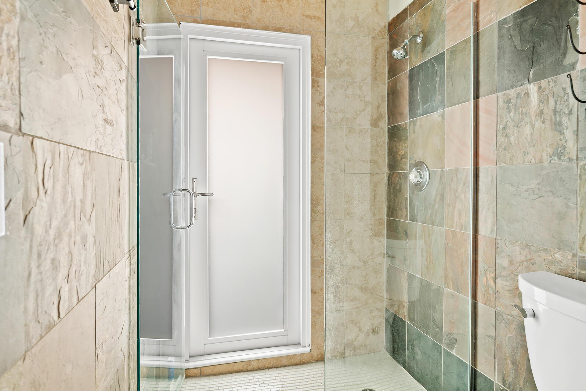 Undisclosed Address Jupiter, FL 33477 - Photo 22 of 107 a bathroom with a shower and a toilet