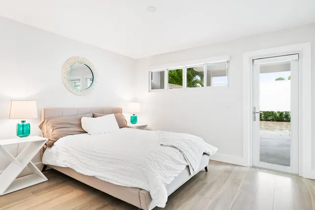 a view of a swimming pool with a table and chairs under an umbrella