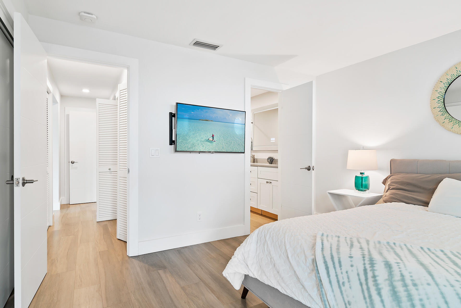 Undisclosed Address Jupiter, FL 33477 - Photo 28 of 107 a bedroom with a bed and wooden floor