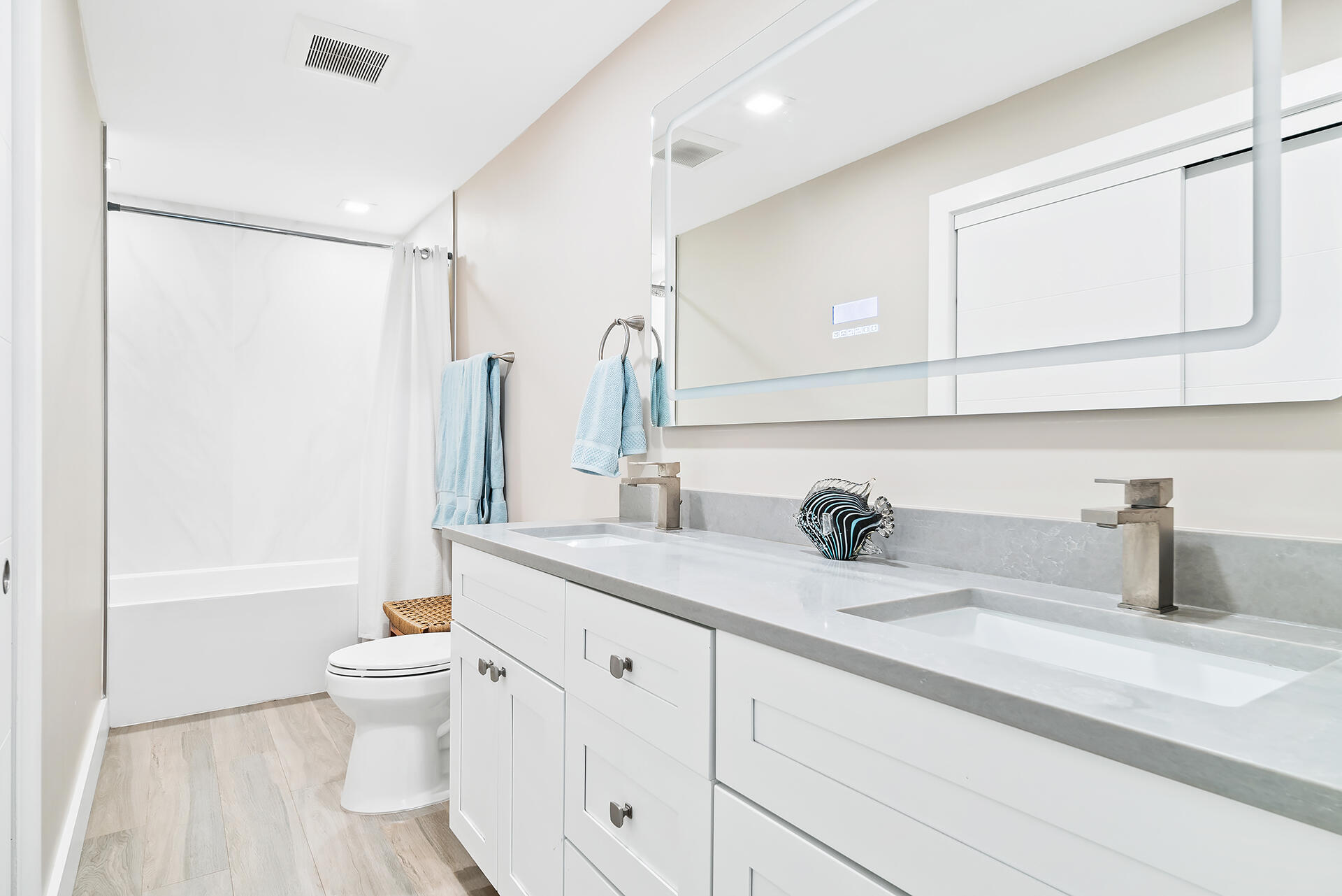 Undisclosed Address Jupiter, FL 33477 - Photo 30 of 107 a bathroom with a double vanity sink a toilet and a tub