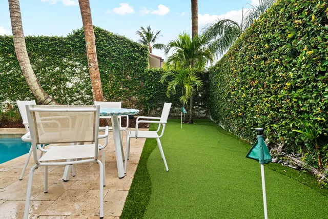 a kitchen with stainless steel appliances granite countertop a refrigerator and a view of living room