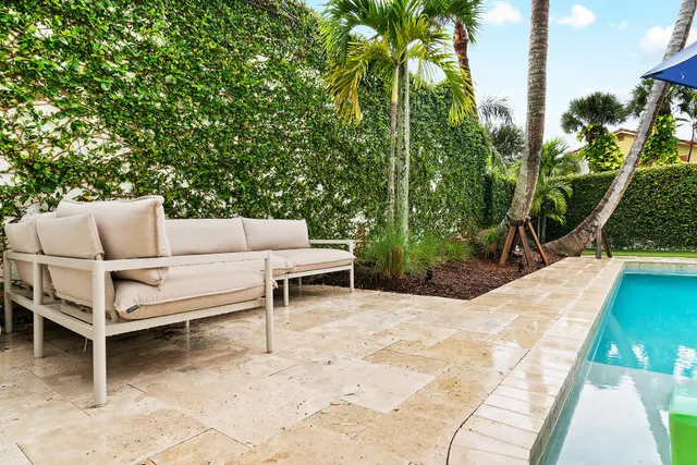 a view of a swimming pool with potted plants