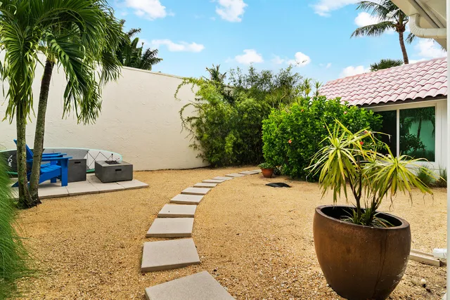 a bedroom with a bed and a large window with wooden floor