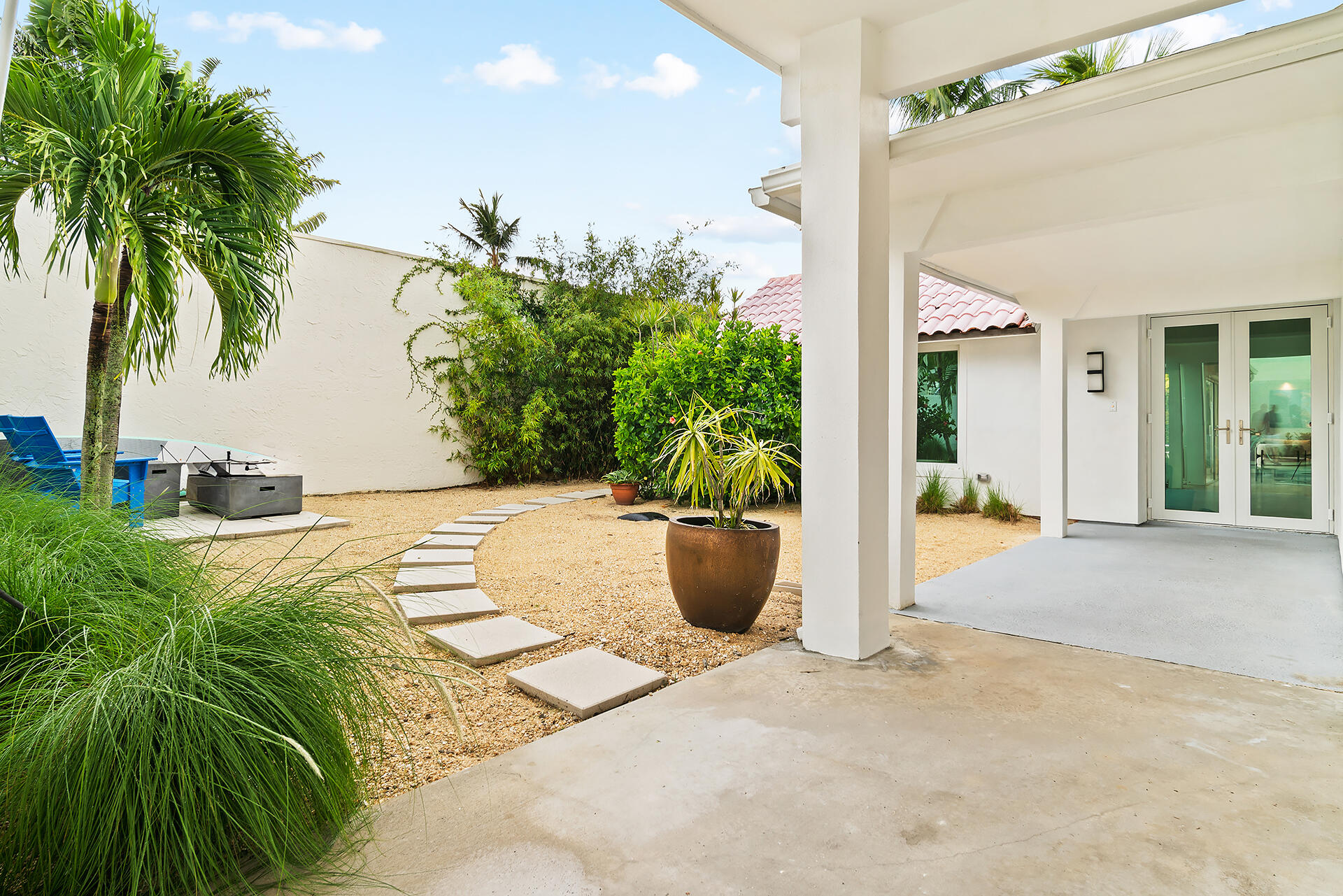 Undisclosed Address Jupiter, FL 33477 - Photo 57 of 107 a view of a swimming pool with potted plants