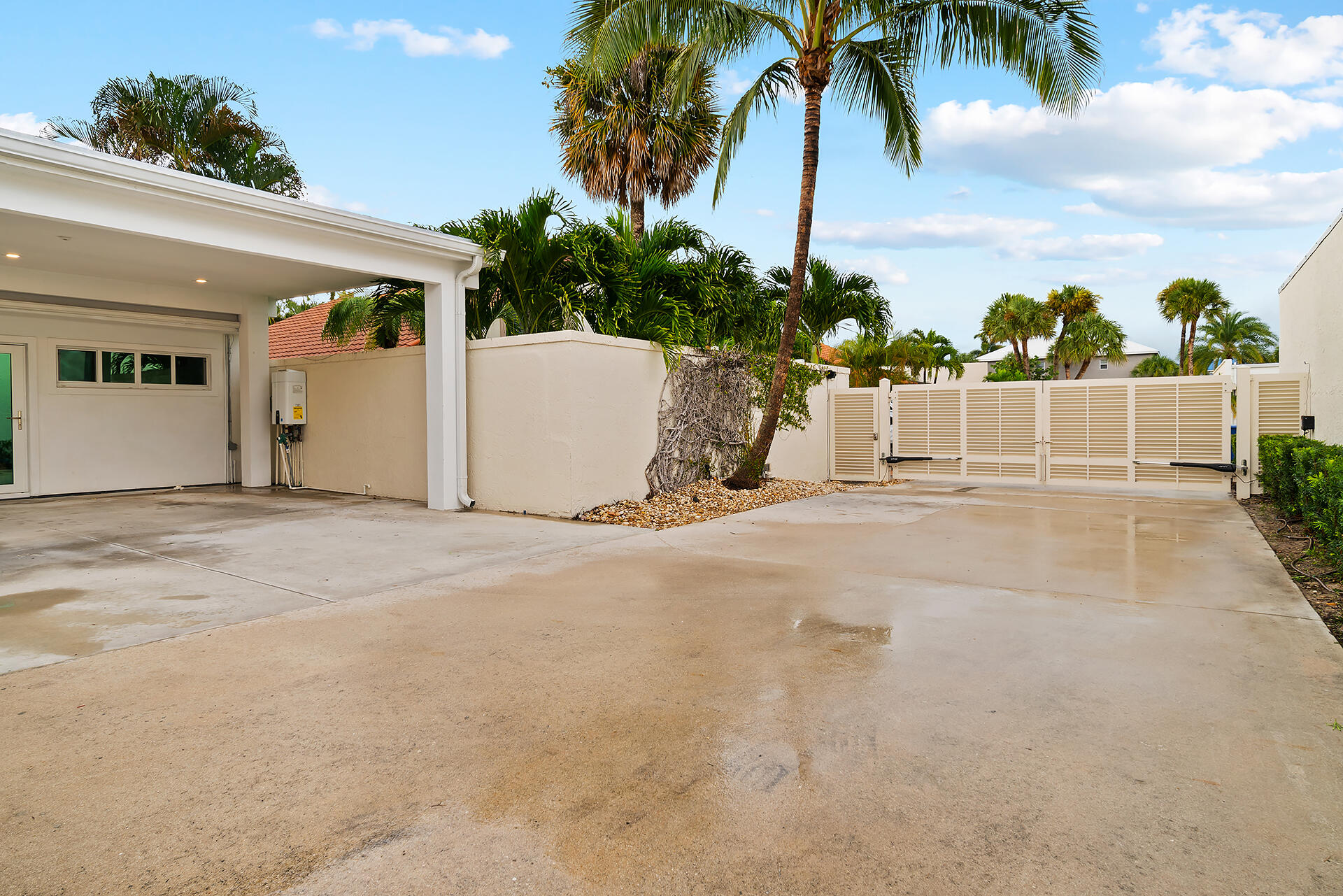 Undisclosed Address Jupiter, FL 33477 - Photo 62 of 107 a view of a house with a yard and potted plants