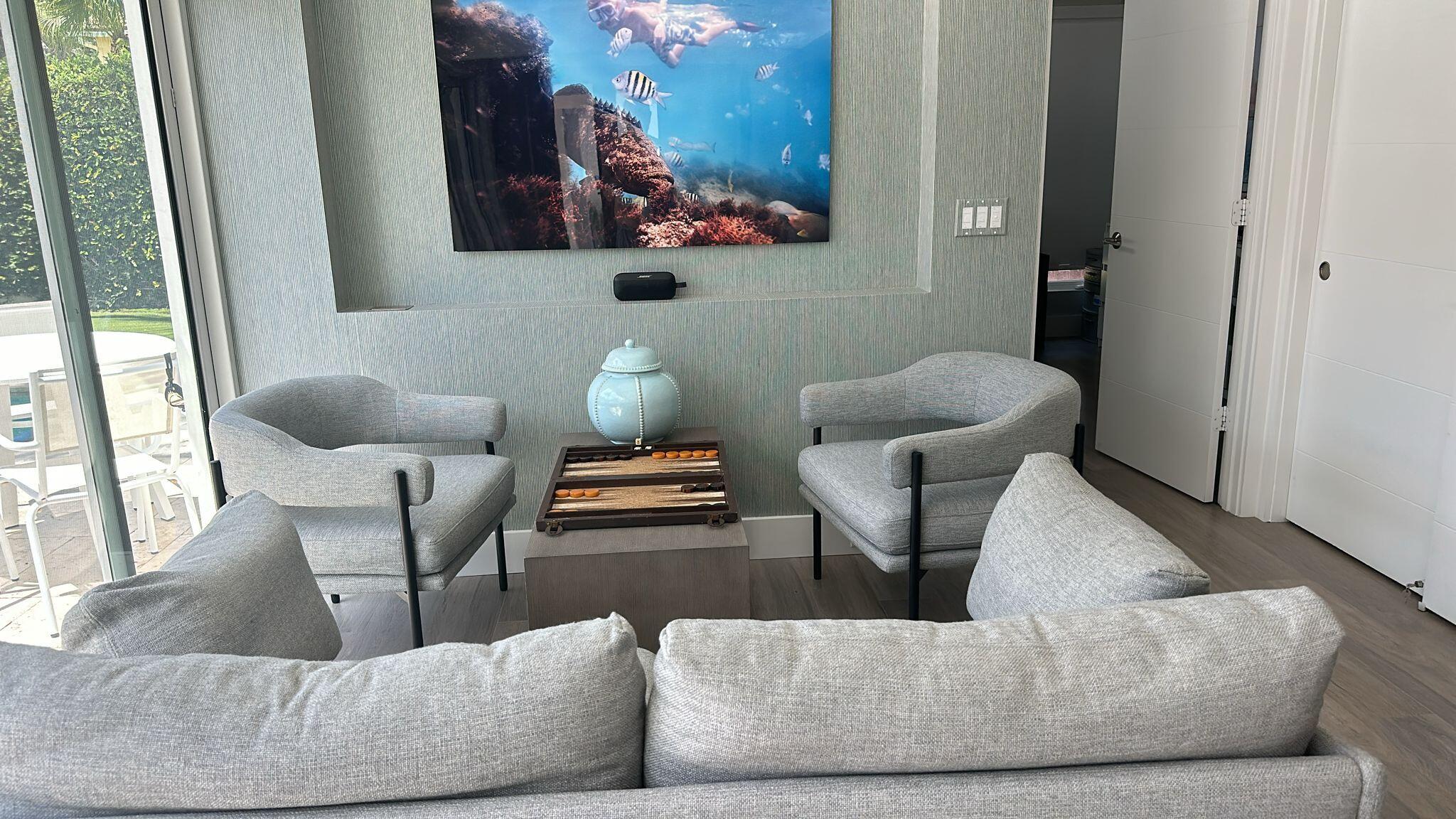 Undisclosed Address Jupiter, FL 33477 - Photo 80 of 107 a living room with furniture and a painting on the wall