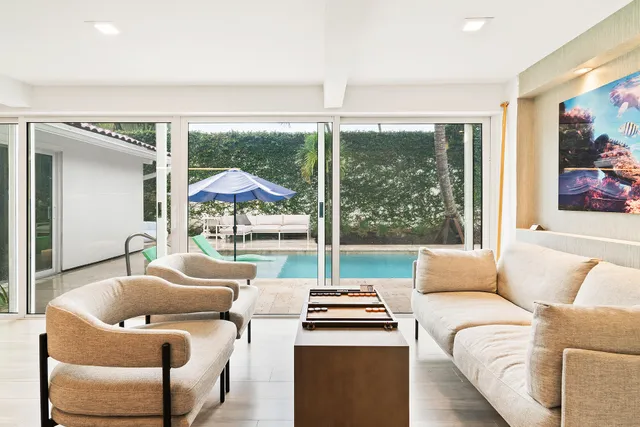 a kitchen with stainless steel appliances granite countertop a stove top oven a sink dishwasher and a dining table with wooden floor