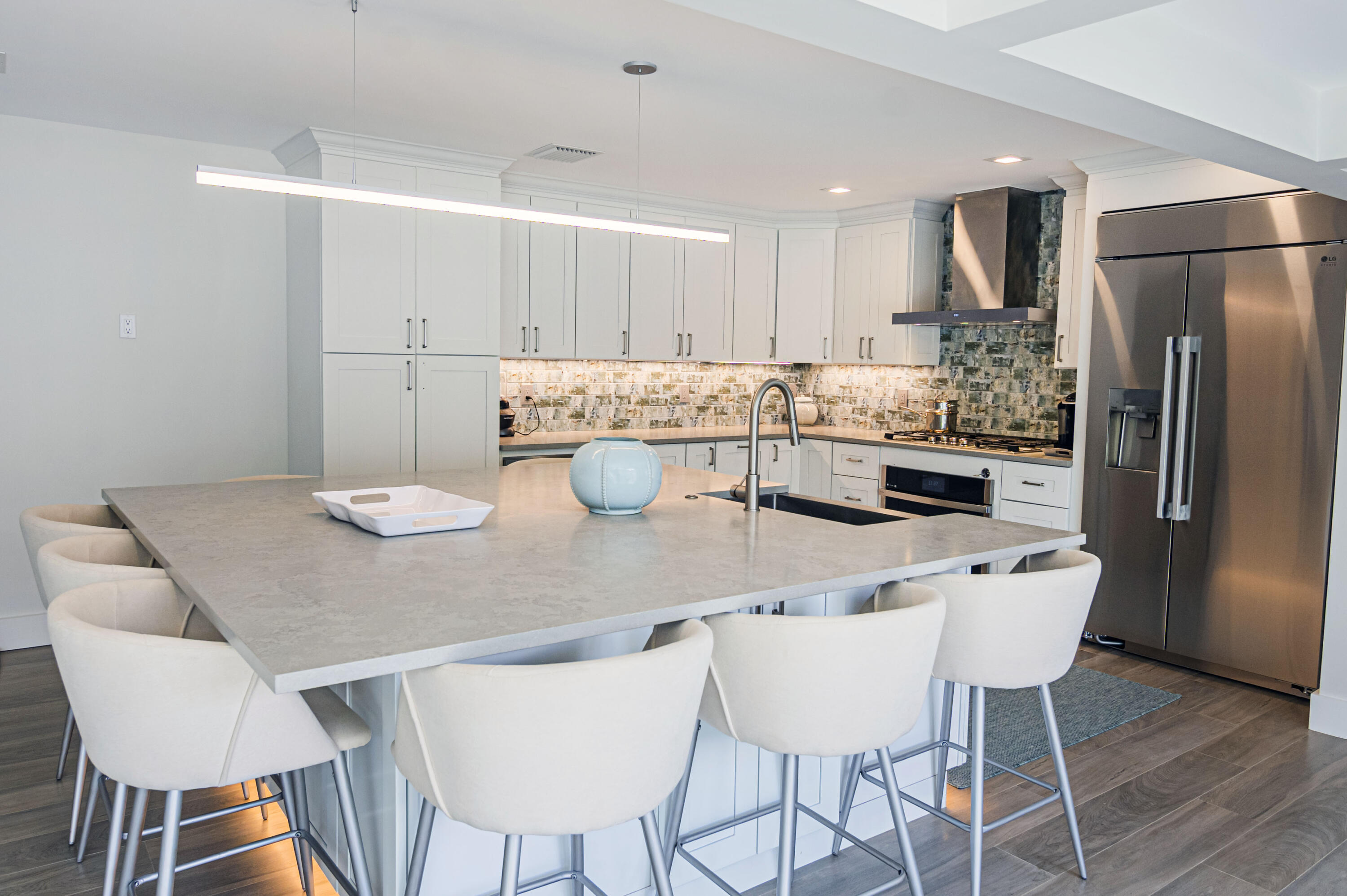 Undisclosed Address Jupiter, FL 33477 - Photo 85 of 107 a kitchen with stainless steel appliances granite countertop a dining table and chairs