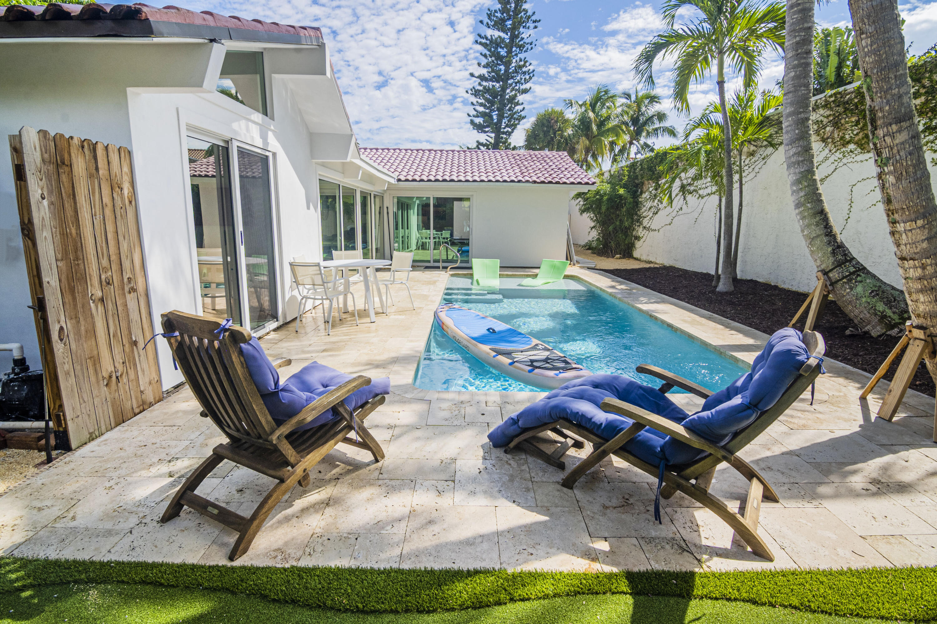 Undisclosed Address Jupiter, FL 33477 - Photo 90 of 107 a living room with a patio