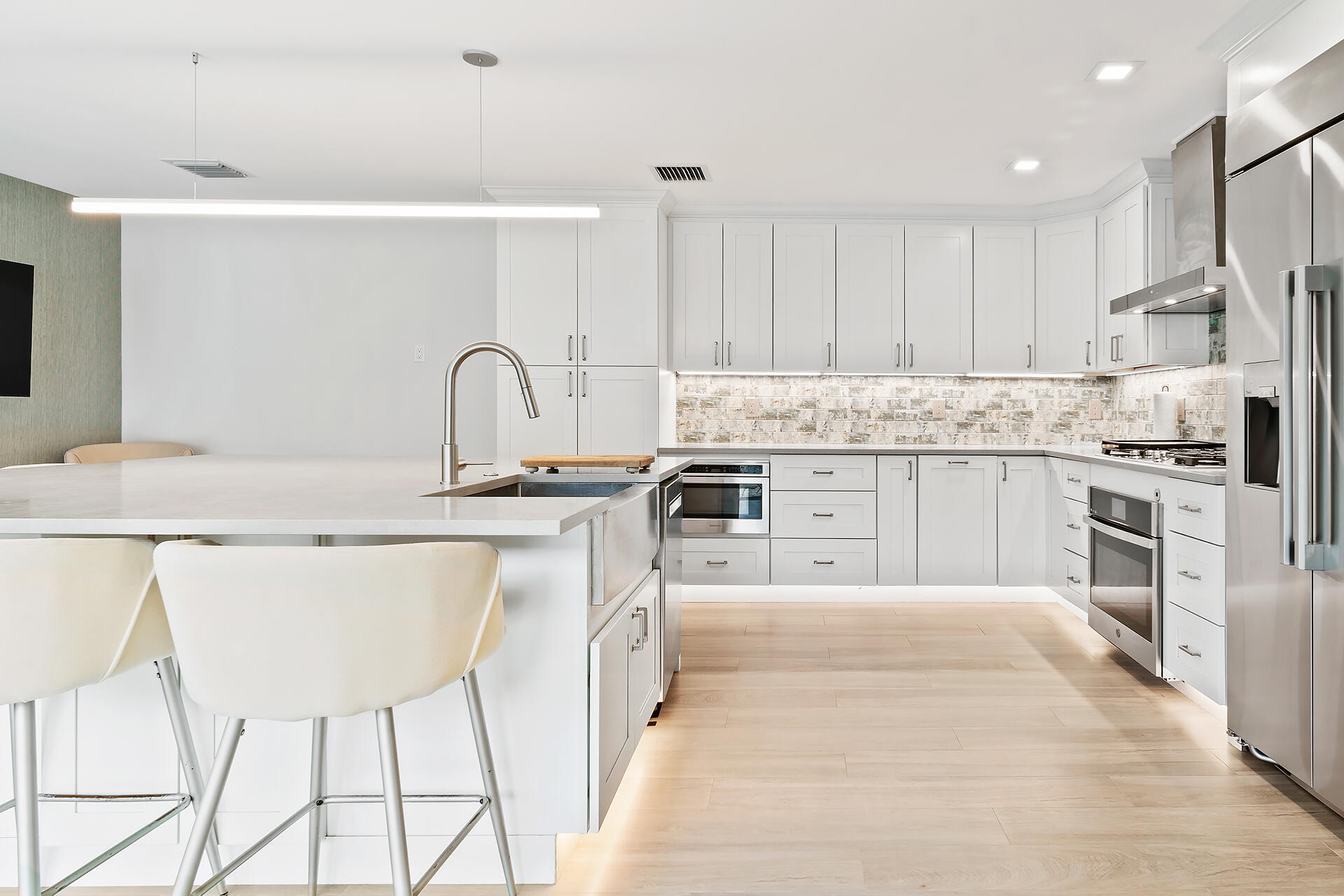 Undisclosed Address Jupiter, FL 33477 - Photo 9 of 107 a kitchen with stainless steel appliances granite countertop a table chairs sink and cabinets