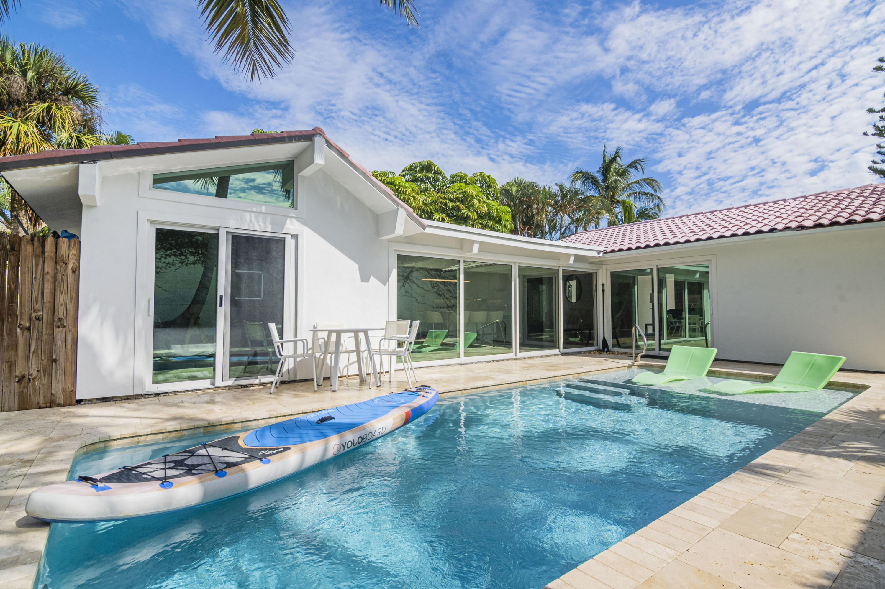 Undisclosed Address Jupiter, FL 33477 - Photo 95 of 107 a house with garden in front of it