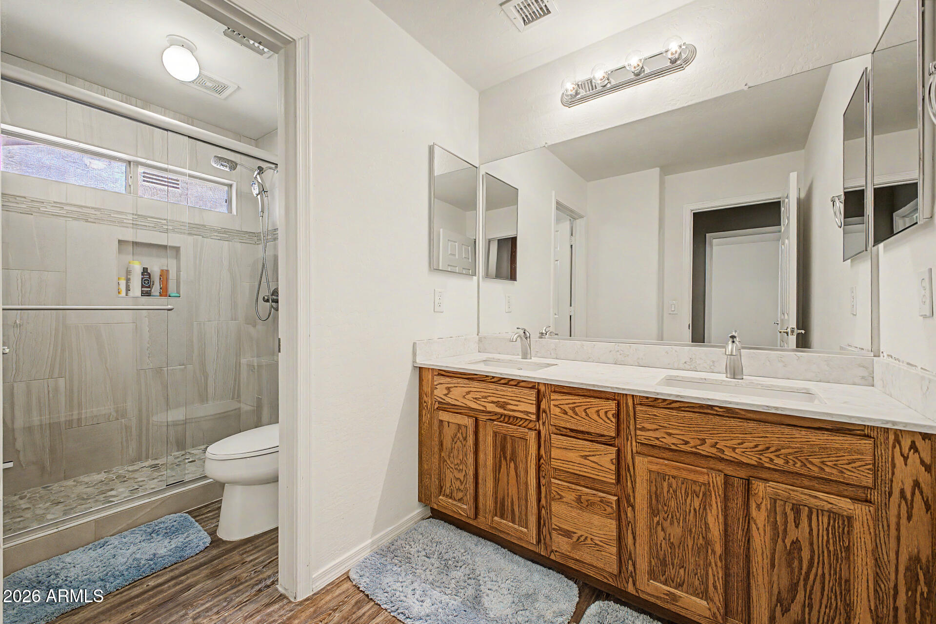 6622 West Harwell Road Laveen, AZ 85339 - Photo 28 of 32 a spacious bathroom with double vanity two mirror and a shower