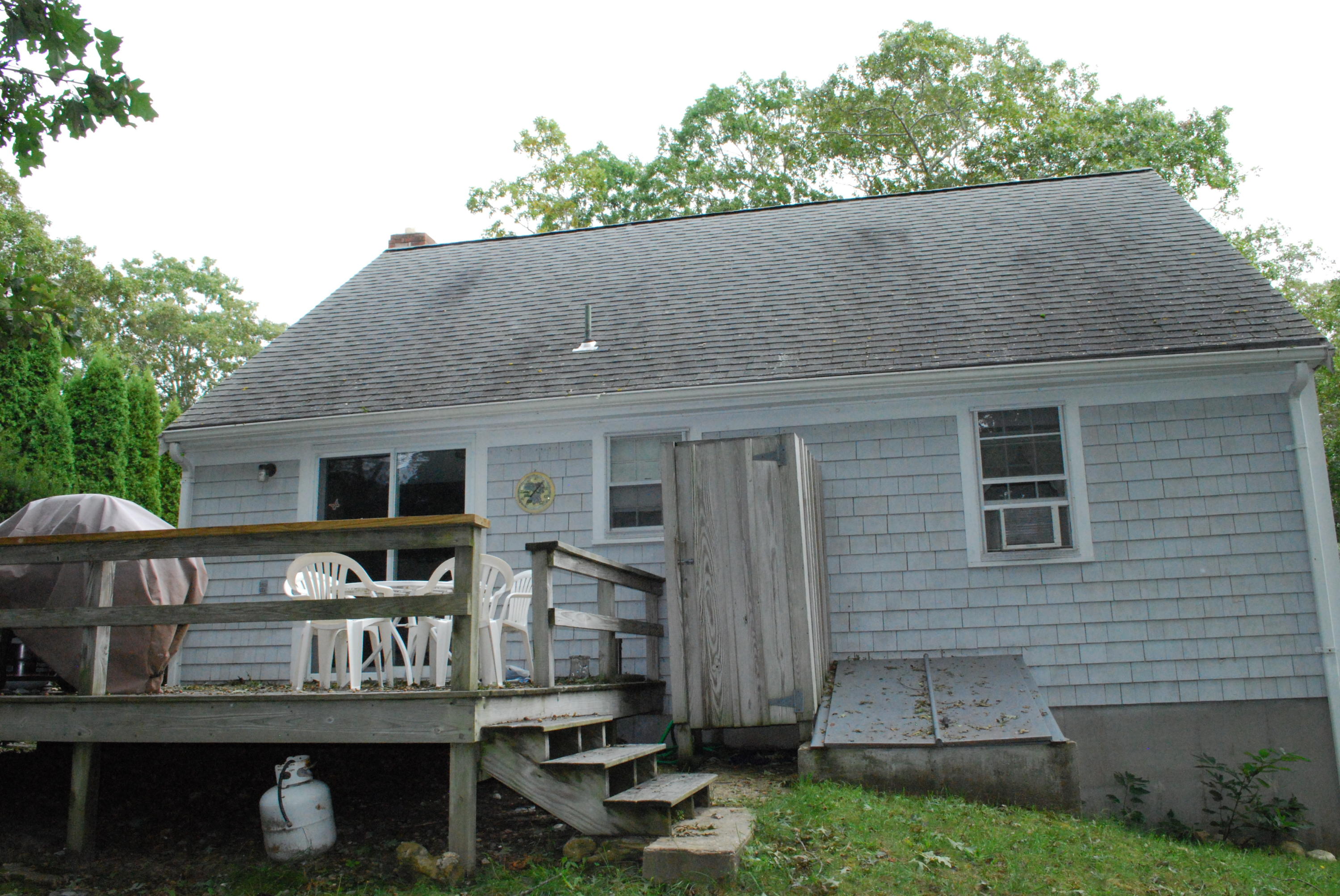 29 Cordwood Road Mashpee, MA 02649 - Photo 18 of 20 a view of a patio with table and chairs with wooden fence