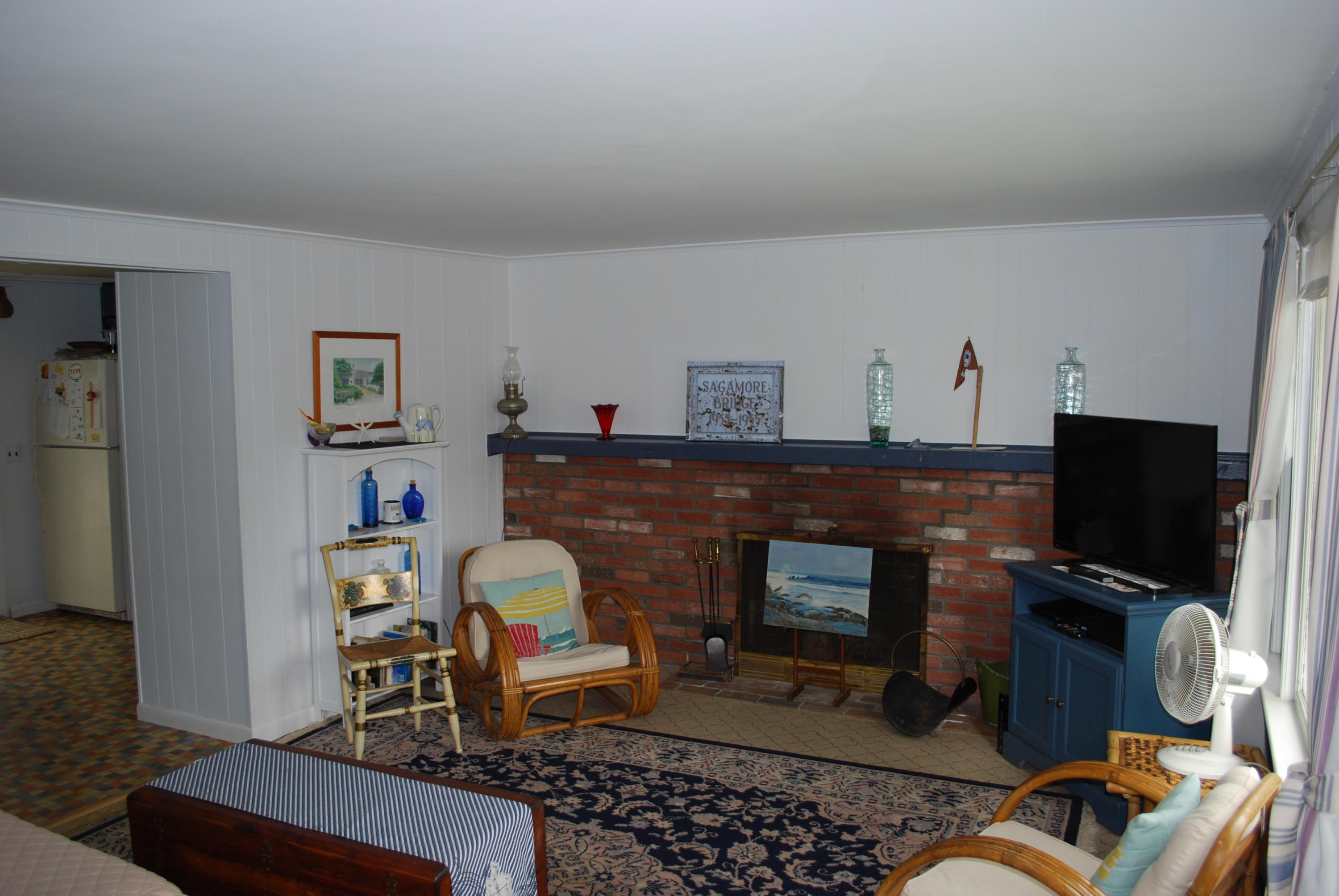 29 Cordwood Road Mashpee, MA 02649 - Photo 3 of 20 a living room with furniture a flat screen tv and a fireplace