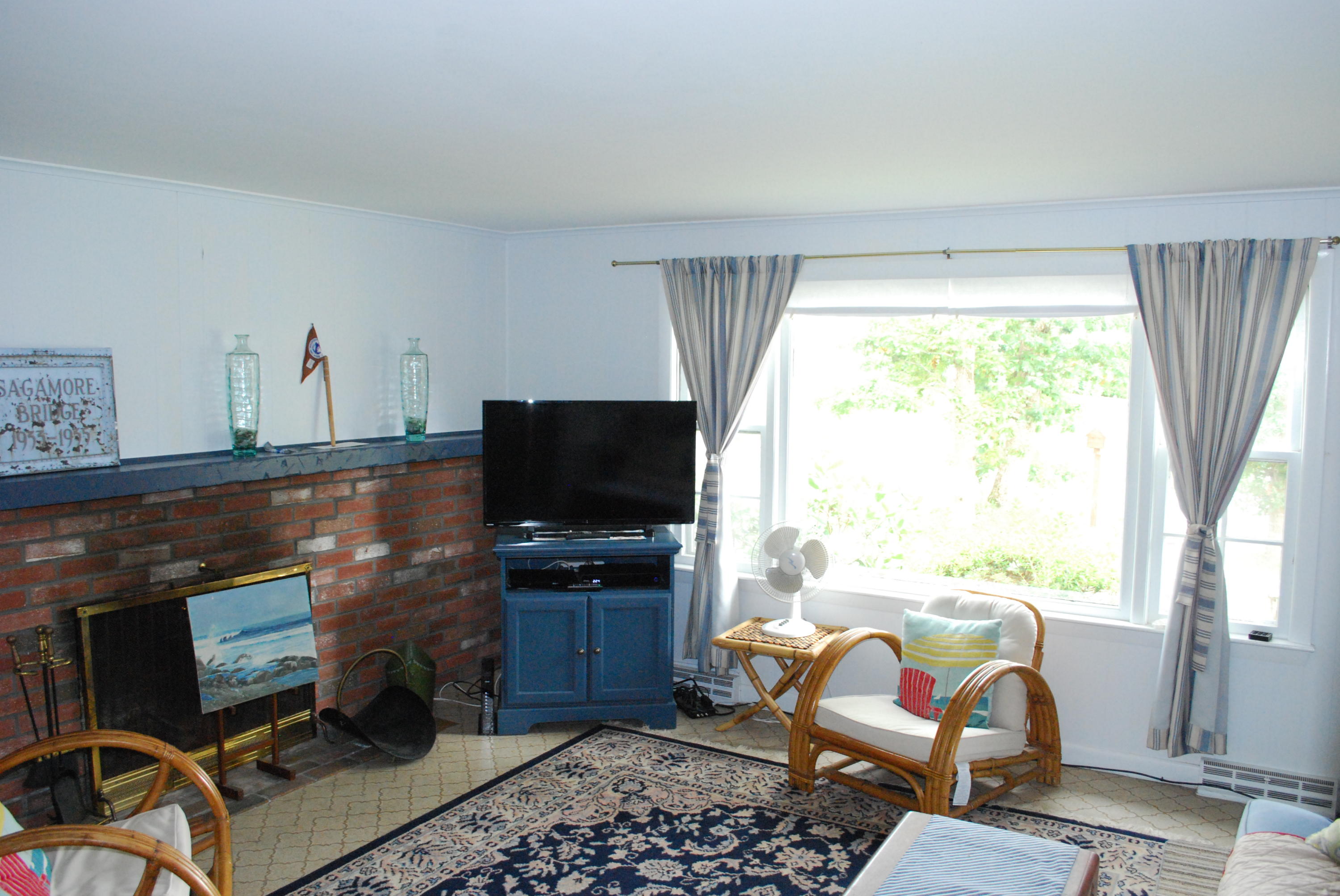 29 Cordwood Road Mashpee, MA 02649 - Photo 5 of 20 a living room with furniture a flat screen tv and a floor to ceiling window
