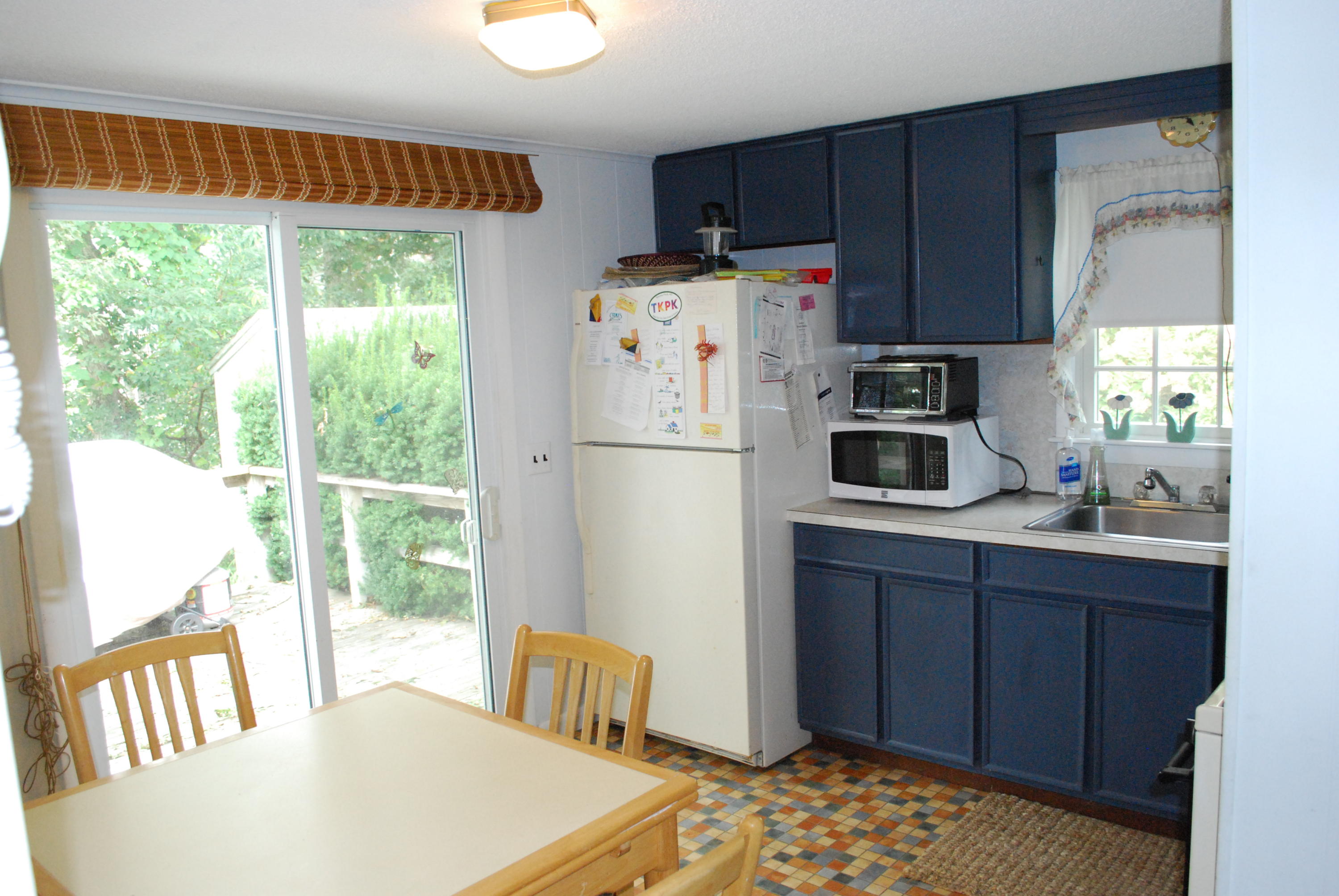 29 Cordwood Road Mashpee, MA 02649 - Photo 6 of 20 a kitchen with a refrigerator a stove top oven a sink and a window