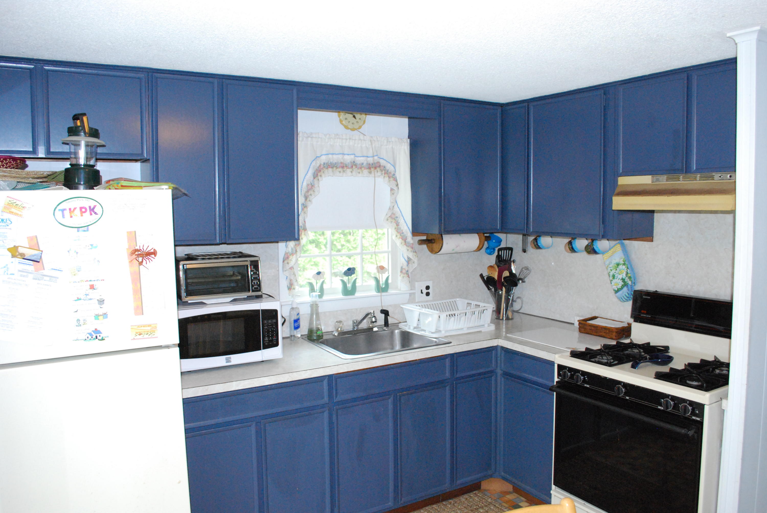 29 Cordwood Road Mashpee, MA 02649 - Photo 7 of 20 a kitchen with stainless steel appliances a stove a refrigerator a sink and wooden cabinets