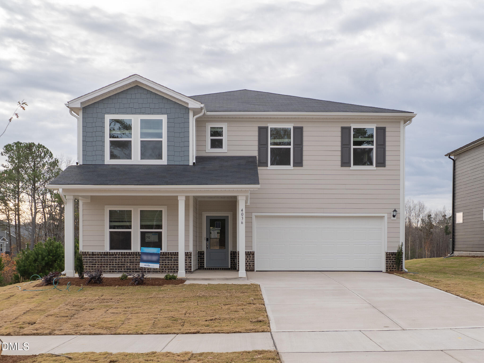 a front view of a house with a yard and a garage