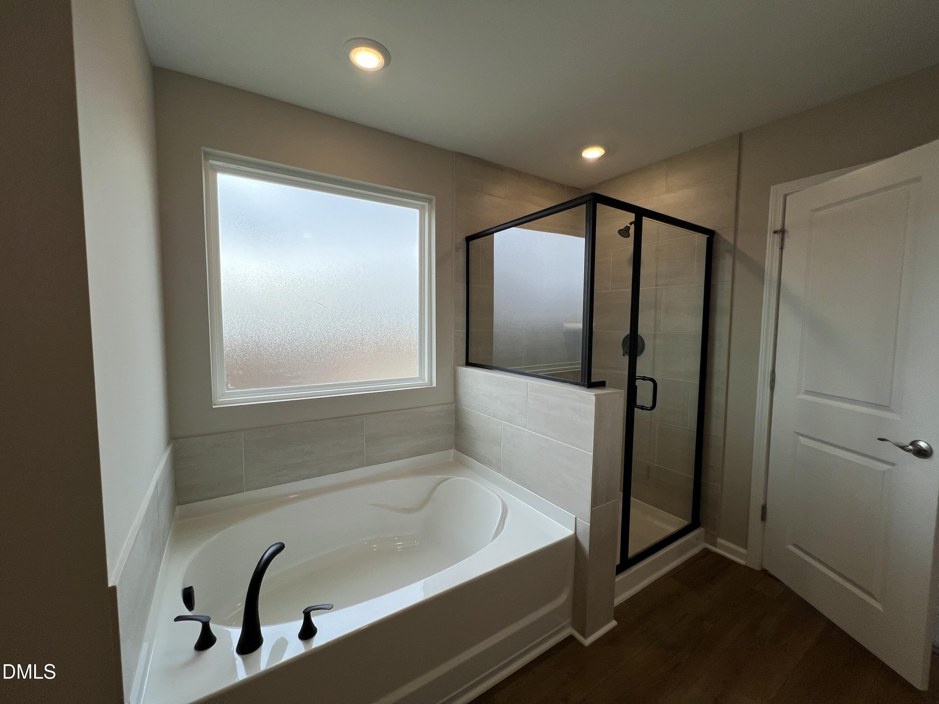 4036 Wesley Chapel Way Raleigh, NC 27616 - Photo 11 of 45 a bathroom with a tub and a shower