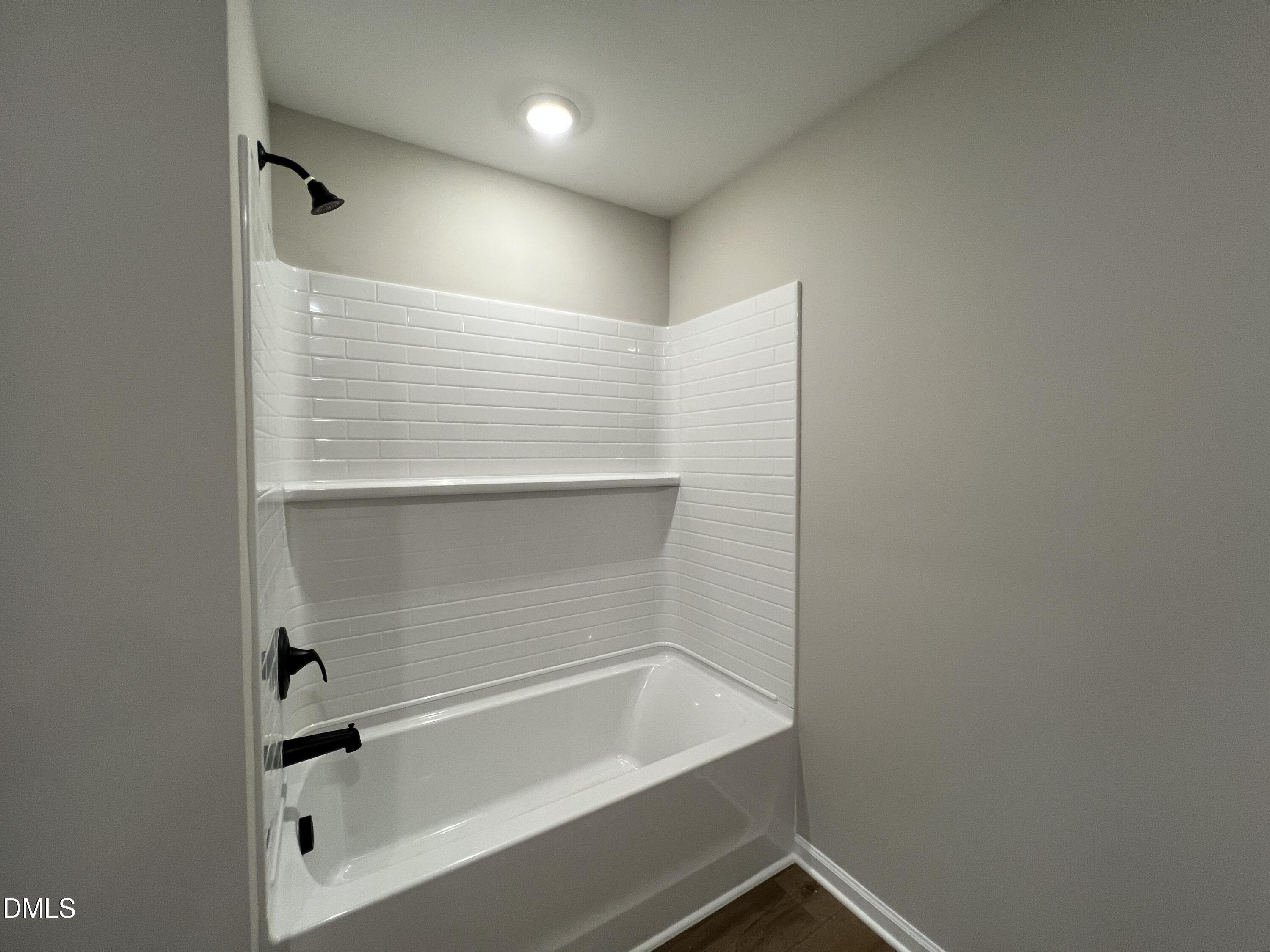 4036 Wesley Chapel Way Raleigh, NC 27616 - Photo 18 of 45 a bathroom with a bathtub