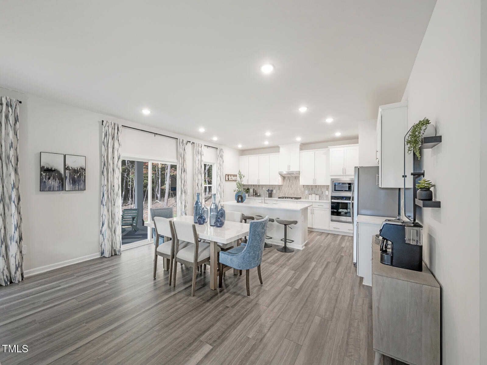 4036 Wesley Chapel Way Raleigh, NC 27616 - Photo 25 of 45 a living room with furniture a wooden floor and a kitchen view