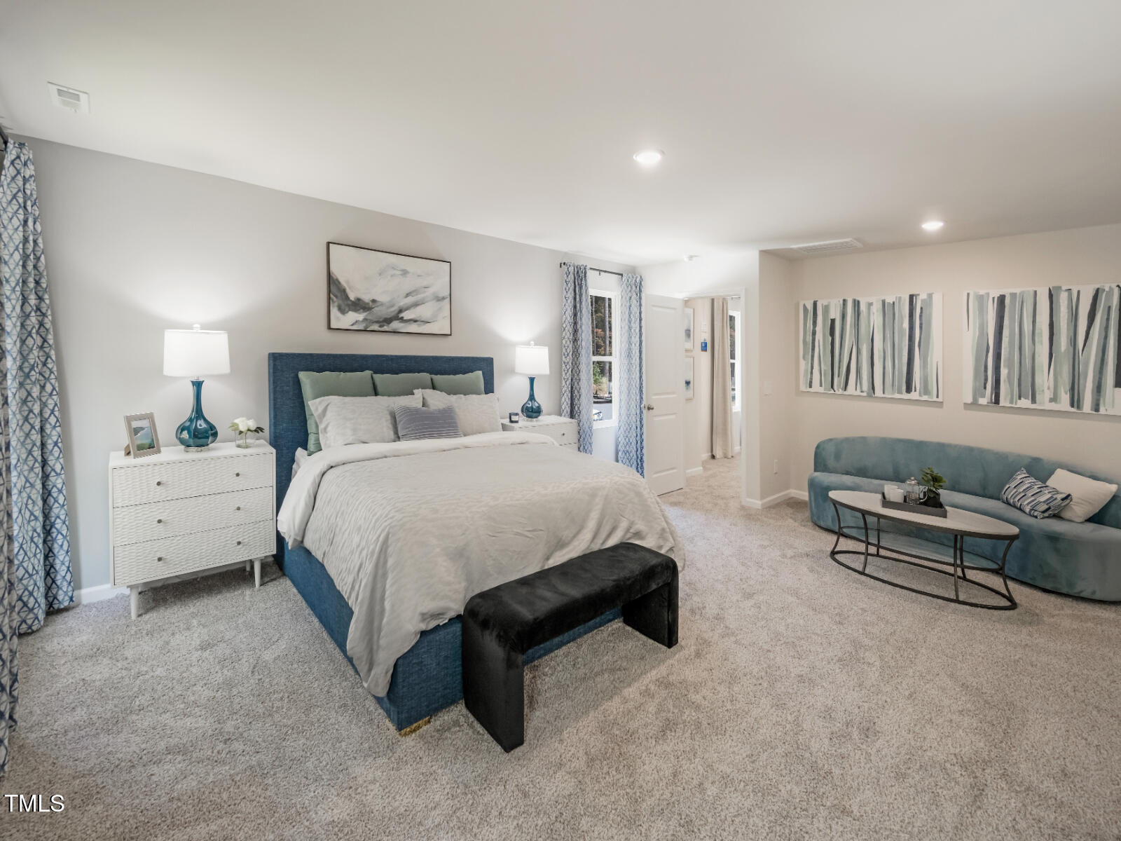 4036 Wesley Chapel Way Raleigh, NC 27616 - Photo 36 of 45 a spacious bedroom with a bed a couch and a view of en suite bathroom