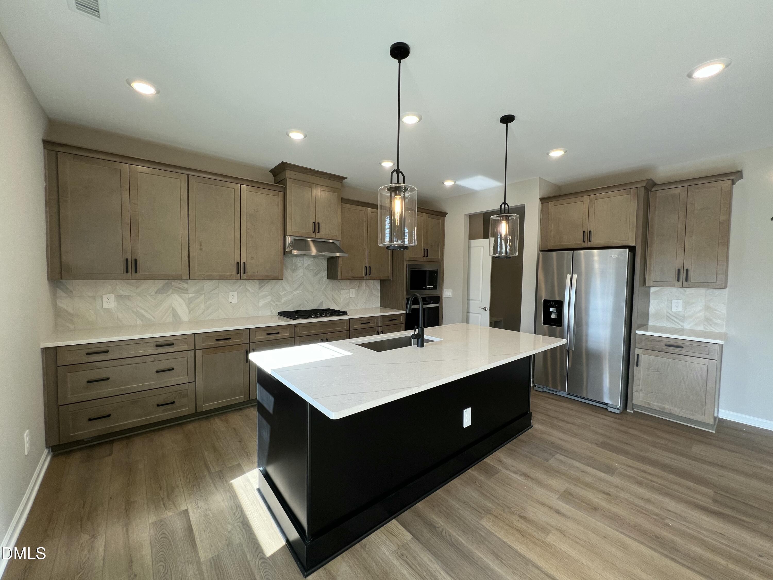 4036 Wesley Chapel Way Raleigh, NC 27616 - Photo 3 of 45 a kitchen with kitchen island a sink stainless steel appliances and cabinets