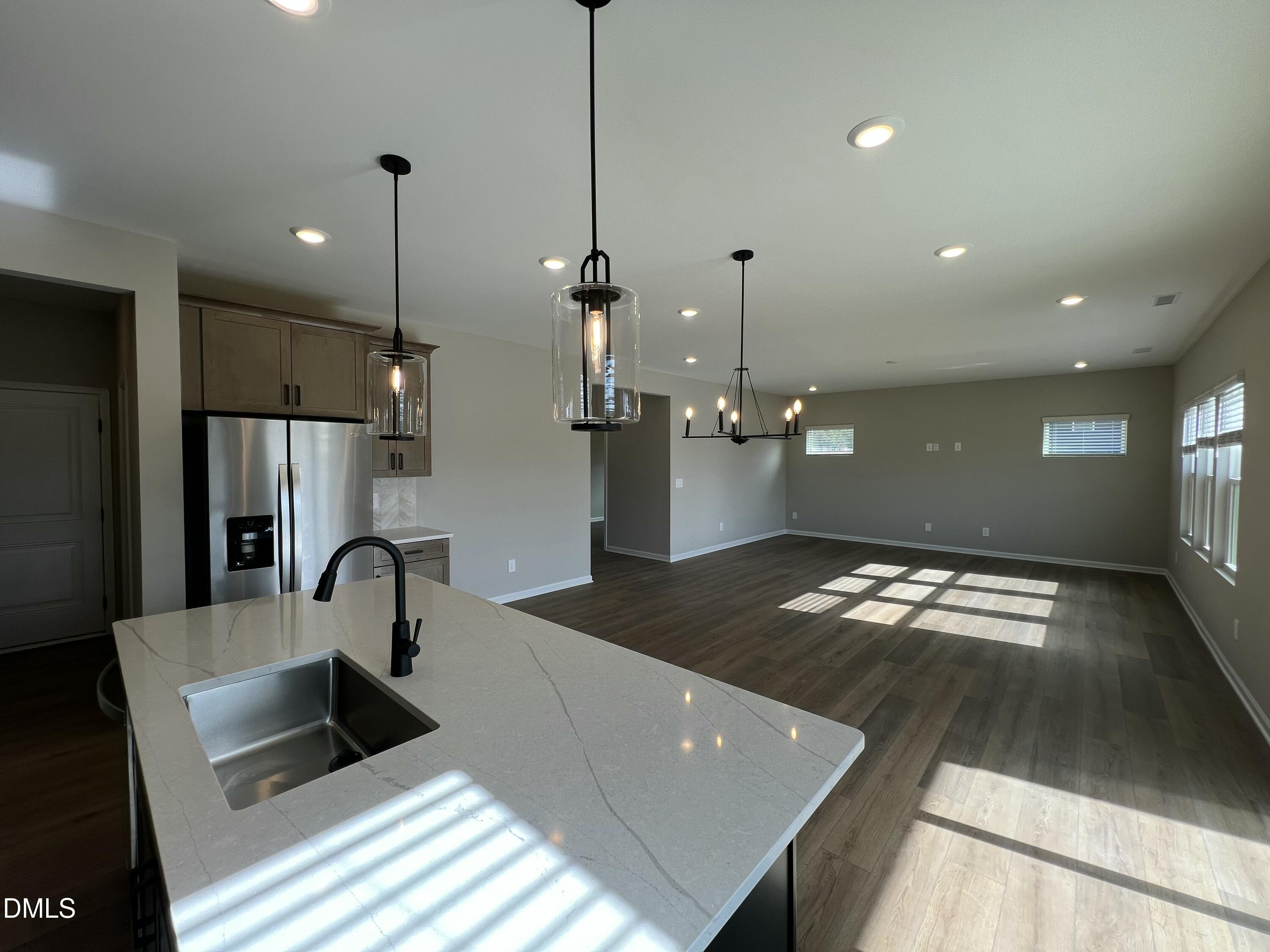 4036 Wesley Chapel Way Raleigh, NC 27616 - Photo 4 of 45 a kitchen with kitchen island a counter top space appliances and a sink