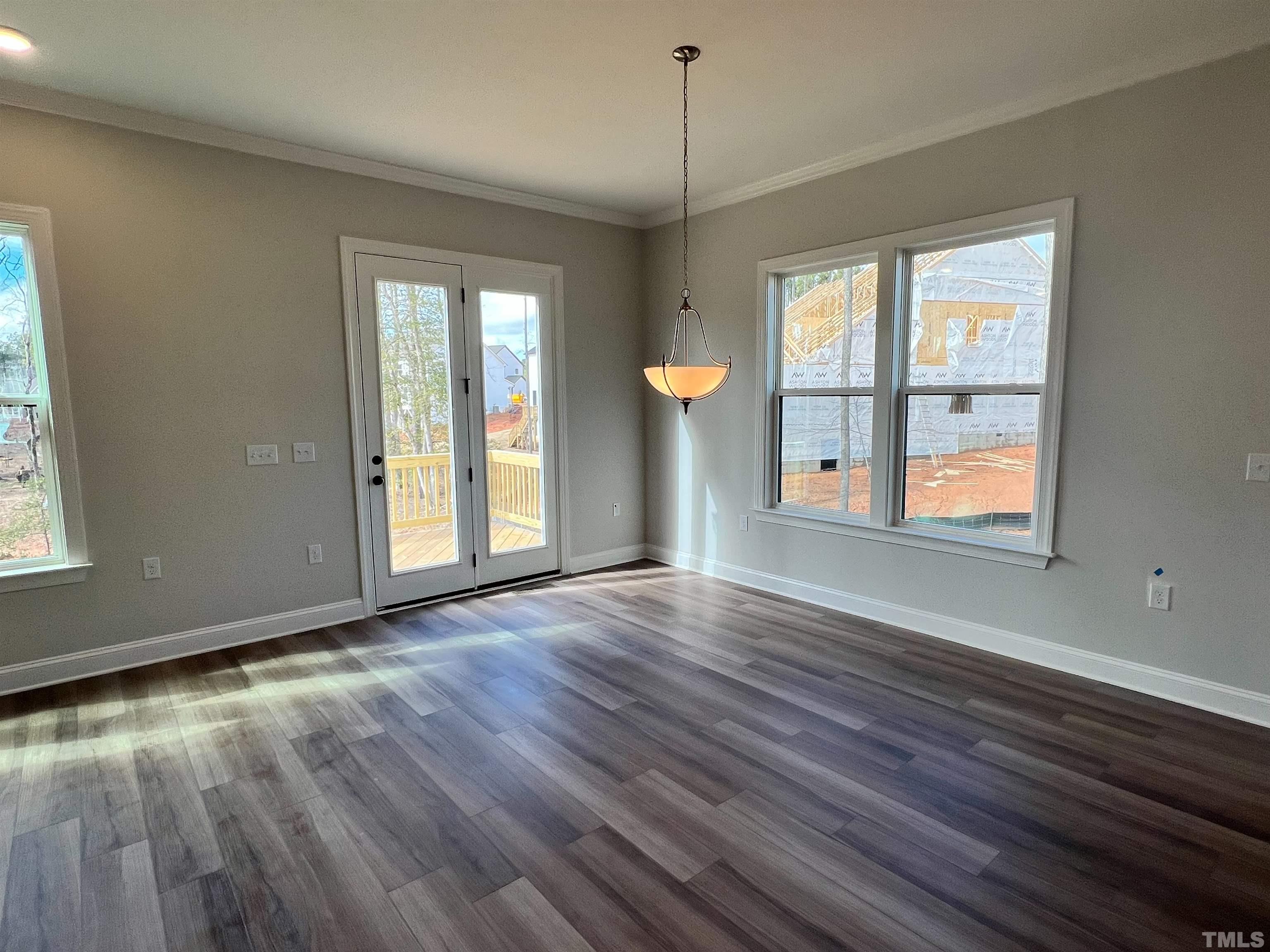 7613 Hasentree Way Wake Forest, NC 27587 - Photo 11 of 39 a view of an empty room with wooden floor and a window
