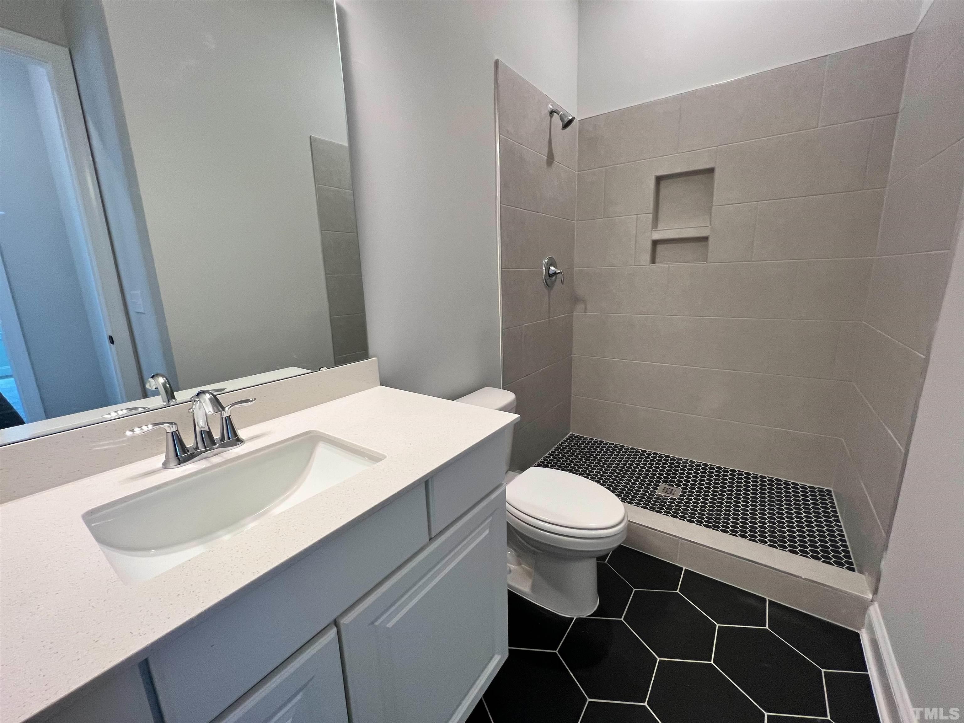 7613 Hasentree Way Wake Forest, NC 27587 - Photo 16 of 39 a bathroom with a sink toilet and a mirror