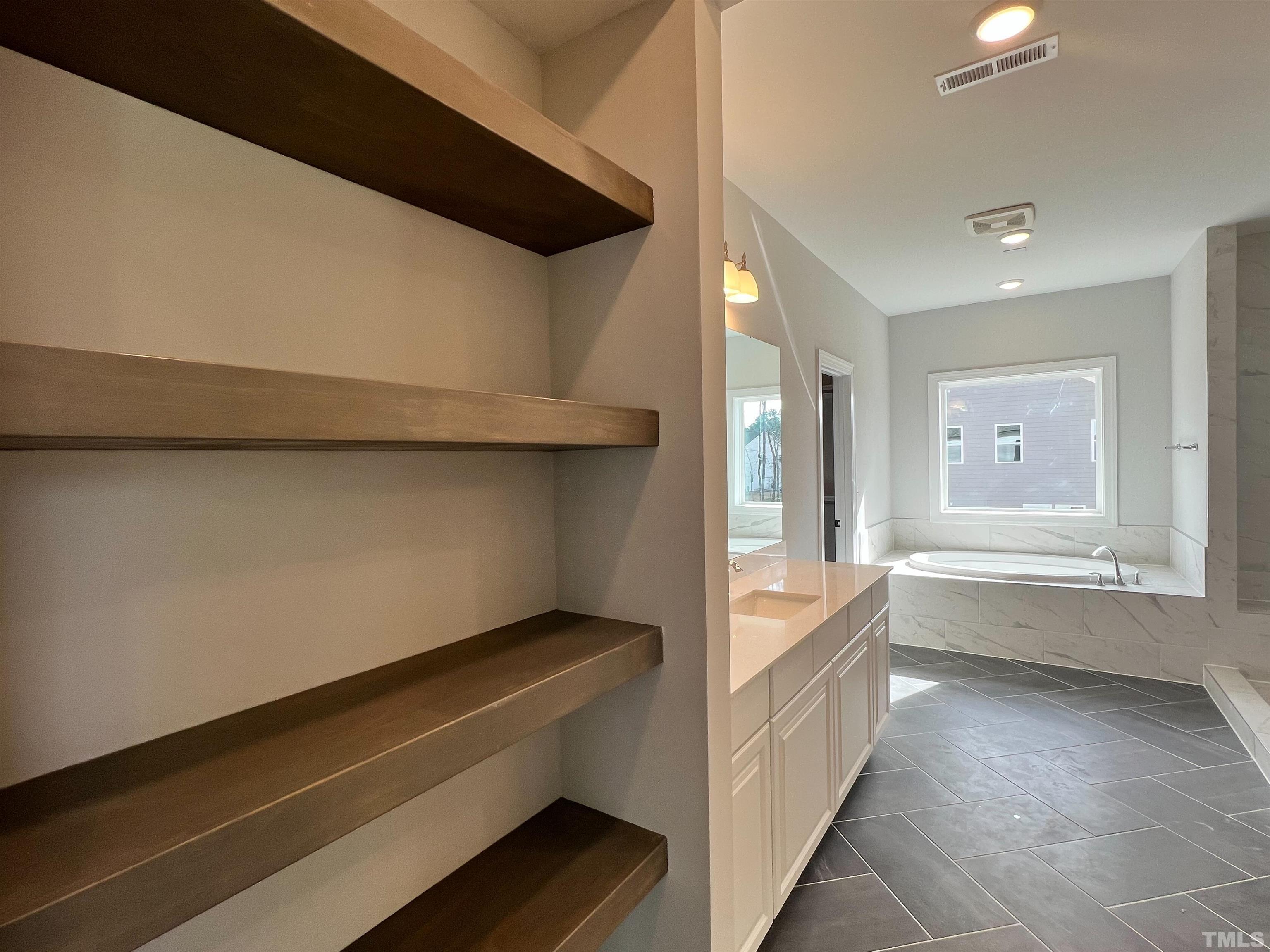 7613 Hasentree Way Wake Forest, NC 27587 - Photo 23 of 39 a bathroom with a bathtub and a sink