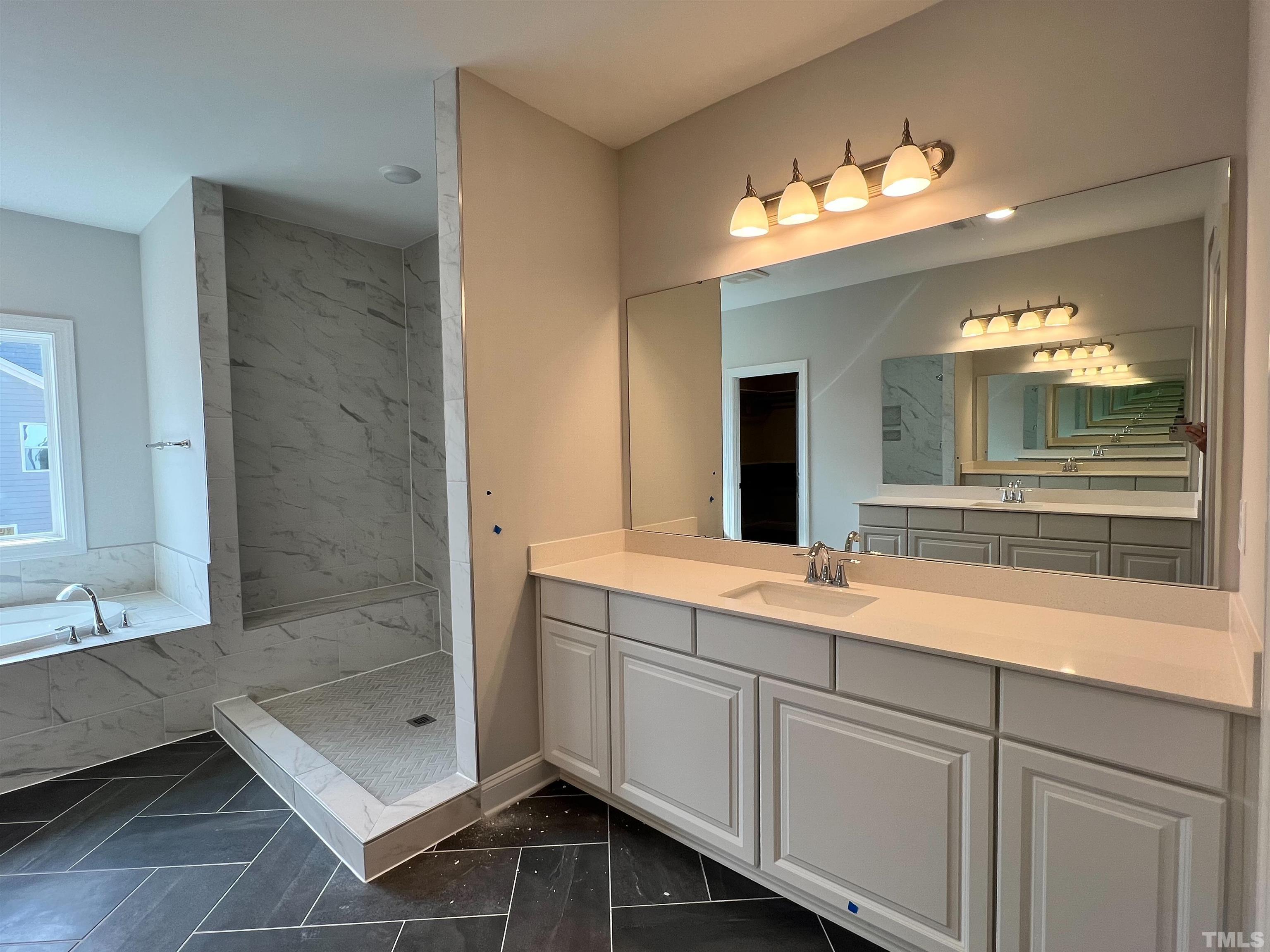 7613 Hasentree Way Wake Forest, NC 27587 - Photo 24 of 39 a bathroom with a sink and a mirror
