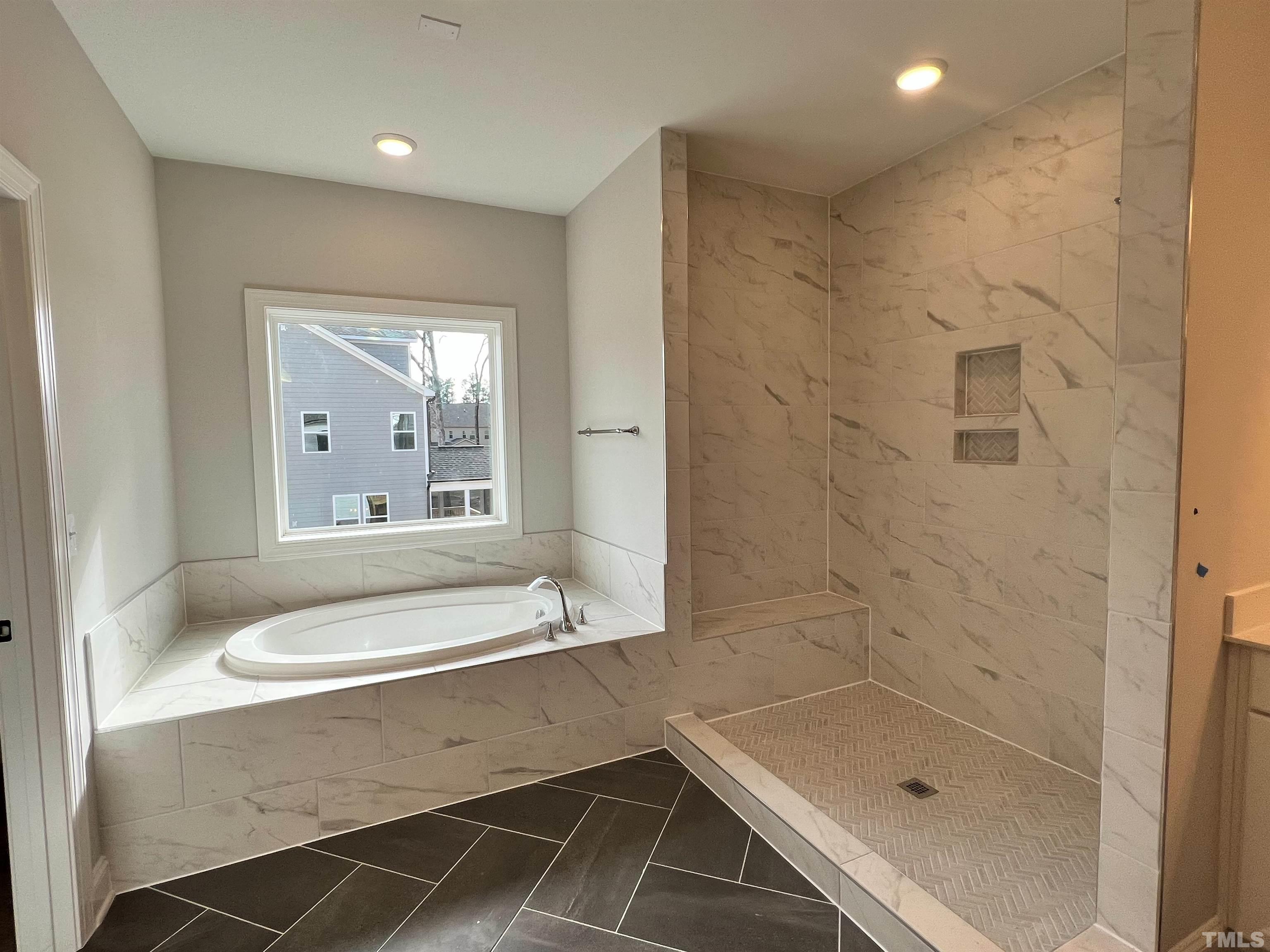 7613 Hasentree Way Wake Forest, NC 27587 - Photo 26 of 39 a bathroom with a tub a sink and a shower