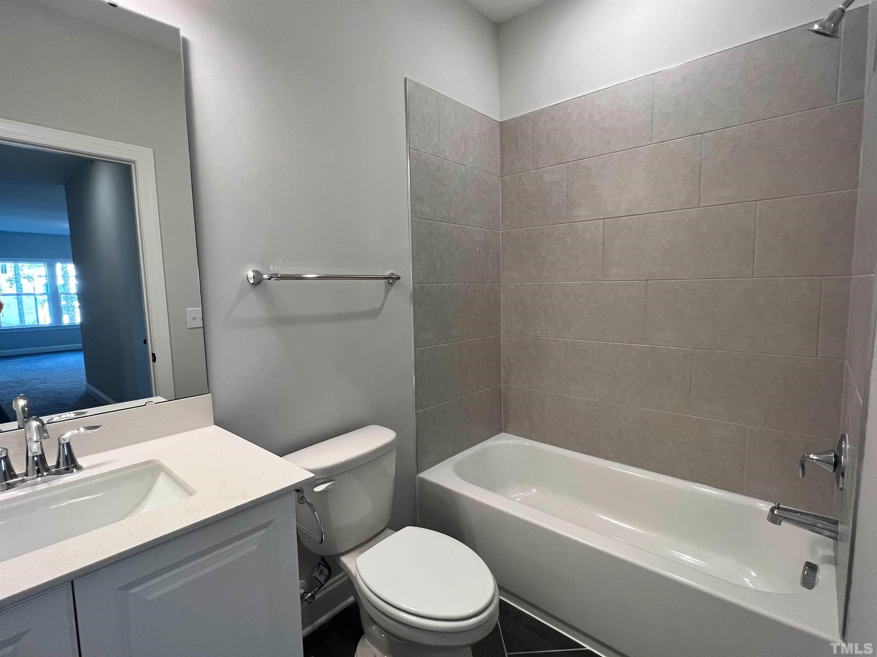 7613 Hasentree Way Wake Forest, NC 27587 - Photo 33 of 39 a bathroom with a sink a toilet and shower