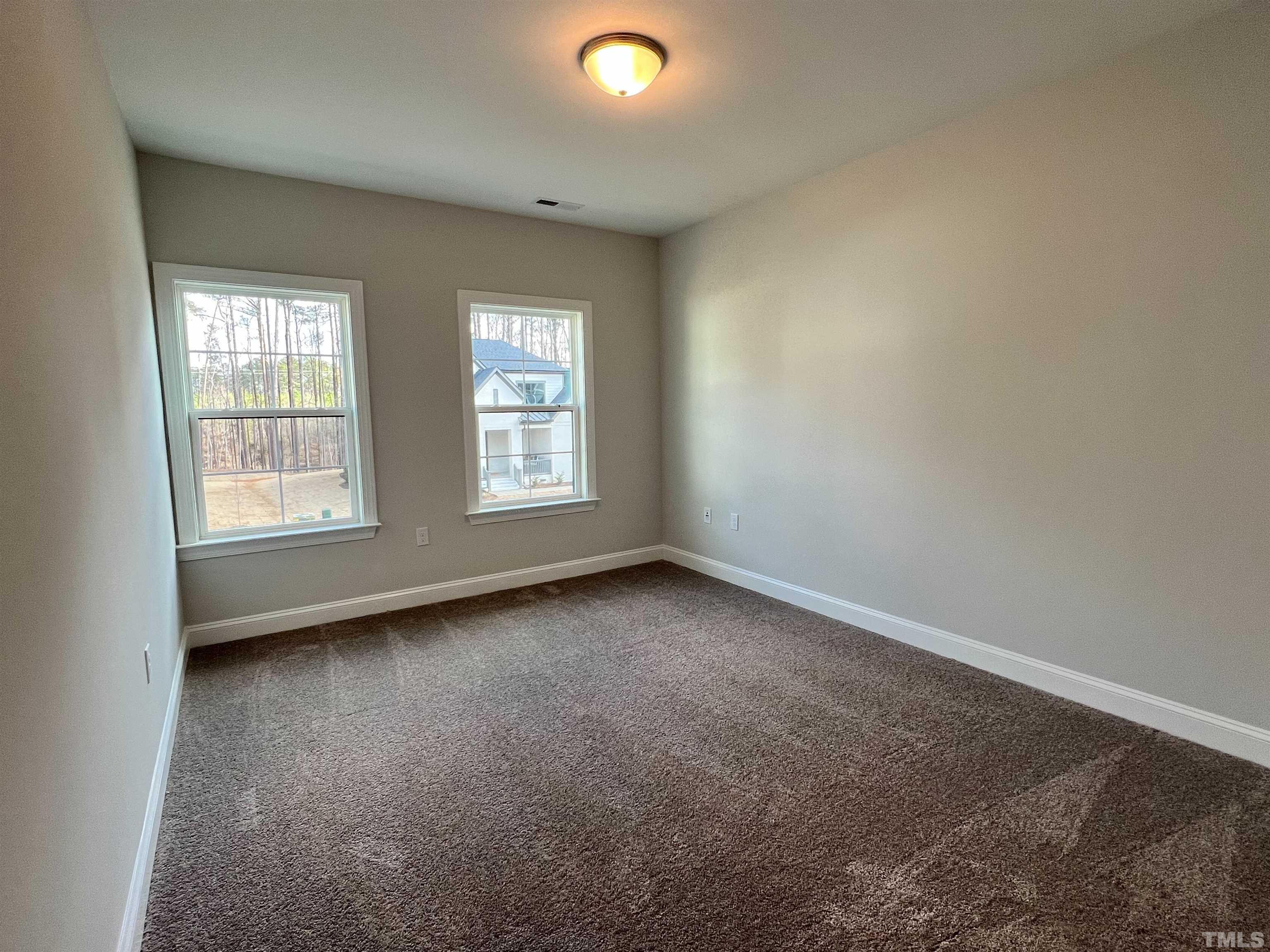 7613 Hasentree Way Wake Forest, NC 27587 - Photo 34 of 39 an empty room with windows and closet