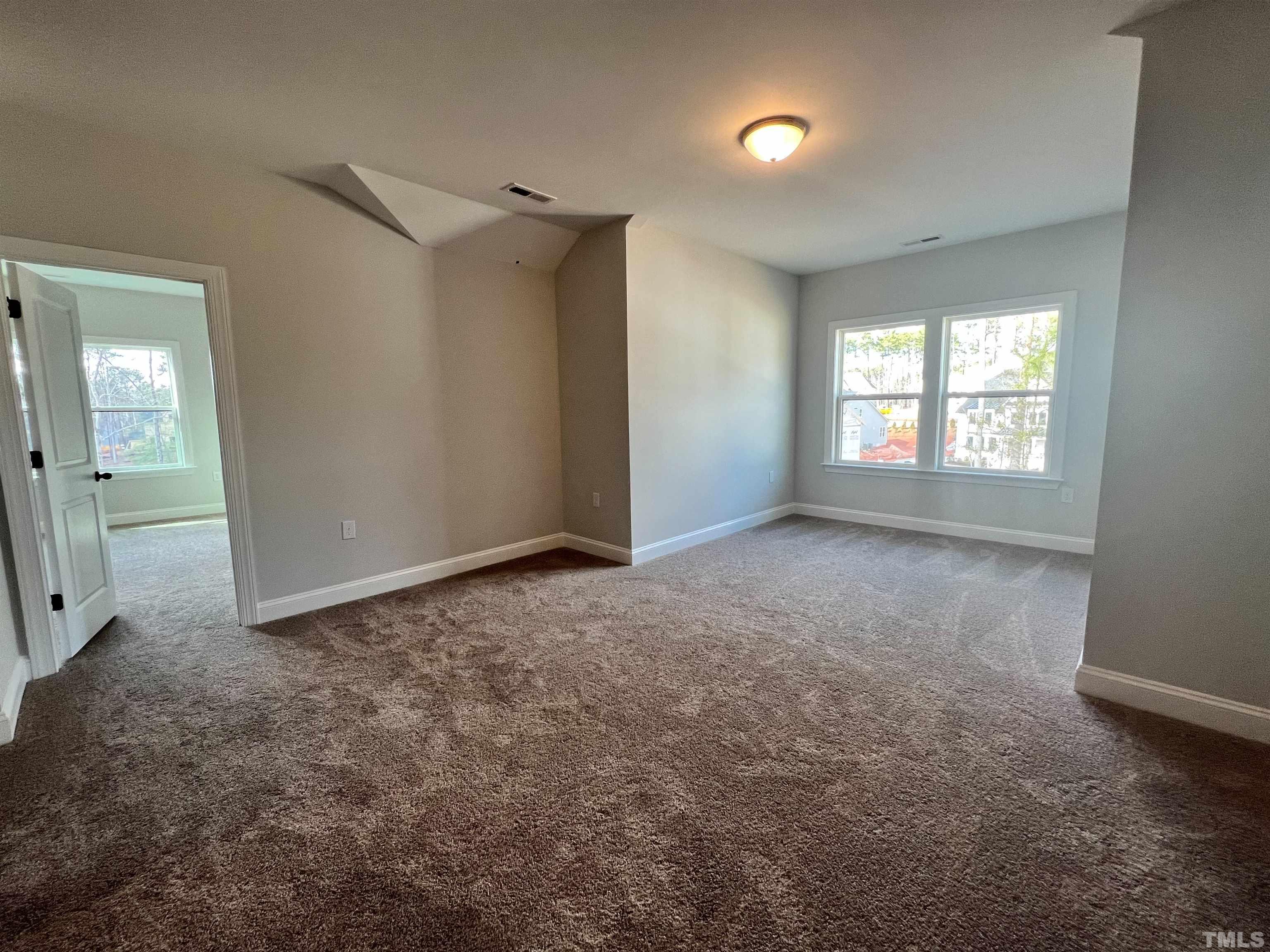 7613 Hasentree Way Wake Forest, NC 27587 - Photo 36 of 39 an empty room with windows and entrance