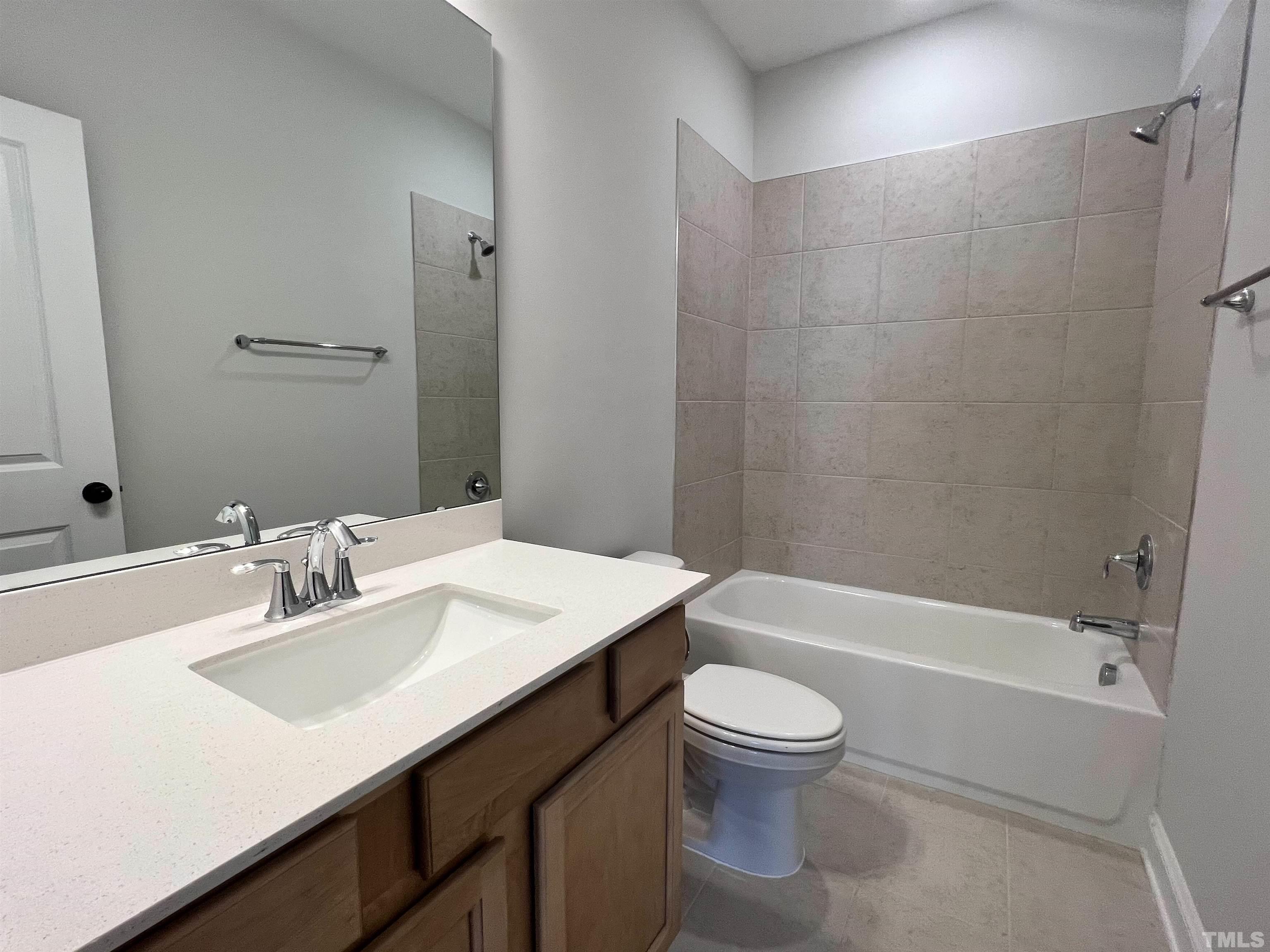 7613 Hasentree Way Wake Forest, NC 27587 - Photo 38 of 39 a bathroom with a sink a toilet and shower