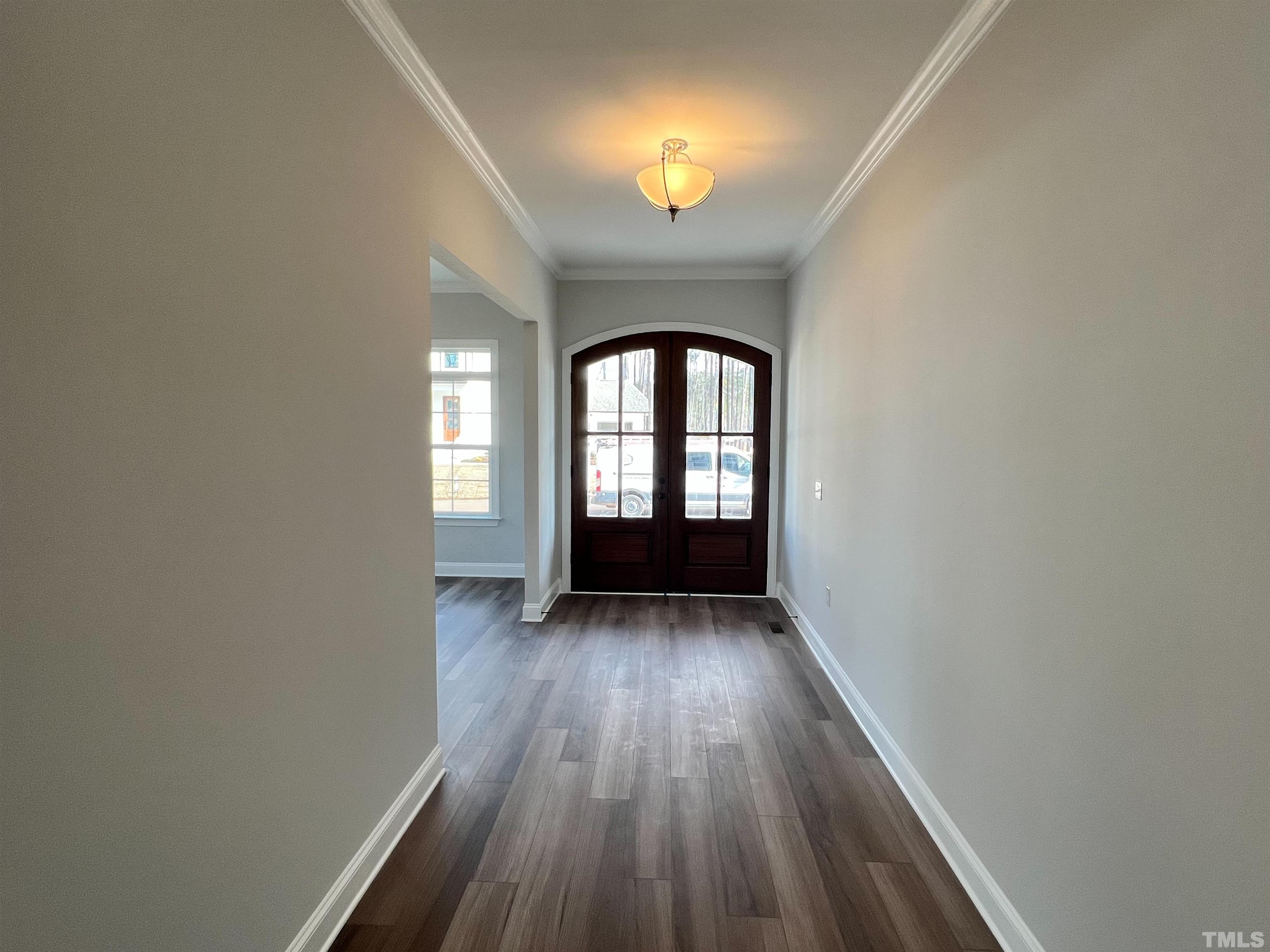 7613 Hasentree Way Wake Forest, NC 27587 - Photo 4 of 39 wooden floor in an empty room with a window