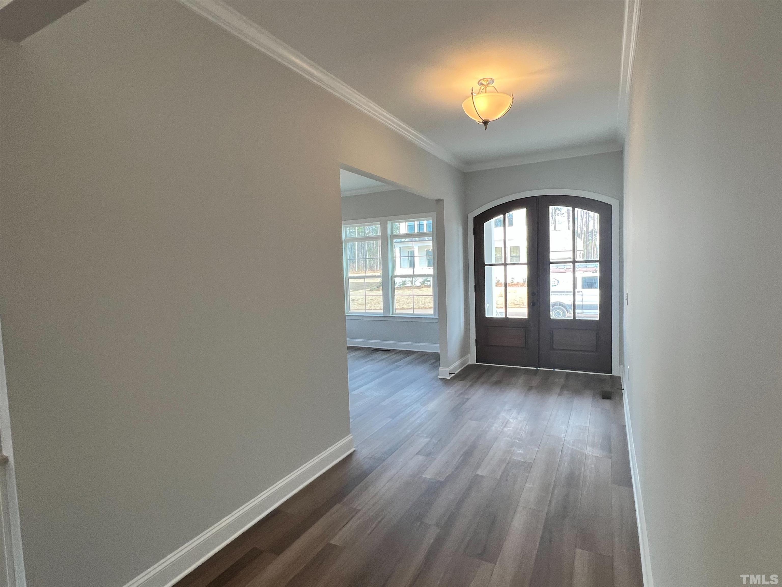 7613 Hasentree Way Wake Forest, NC 27587 - Photo 5 of 39 an empty room with wooden floor and windows