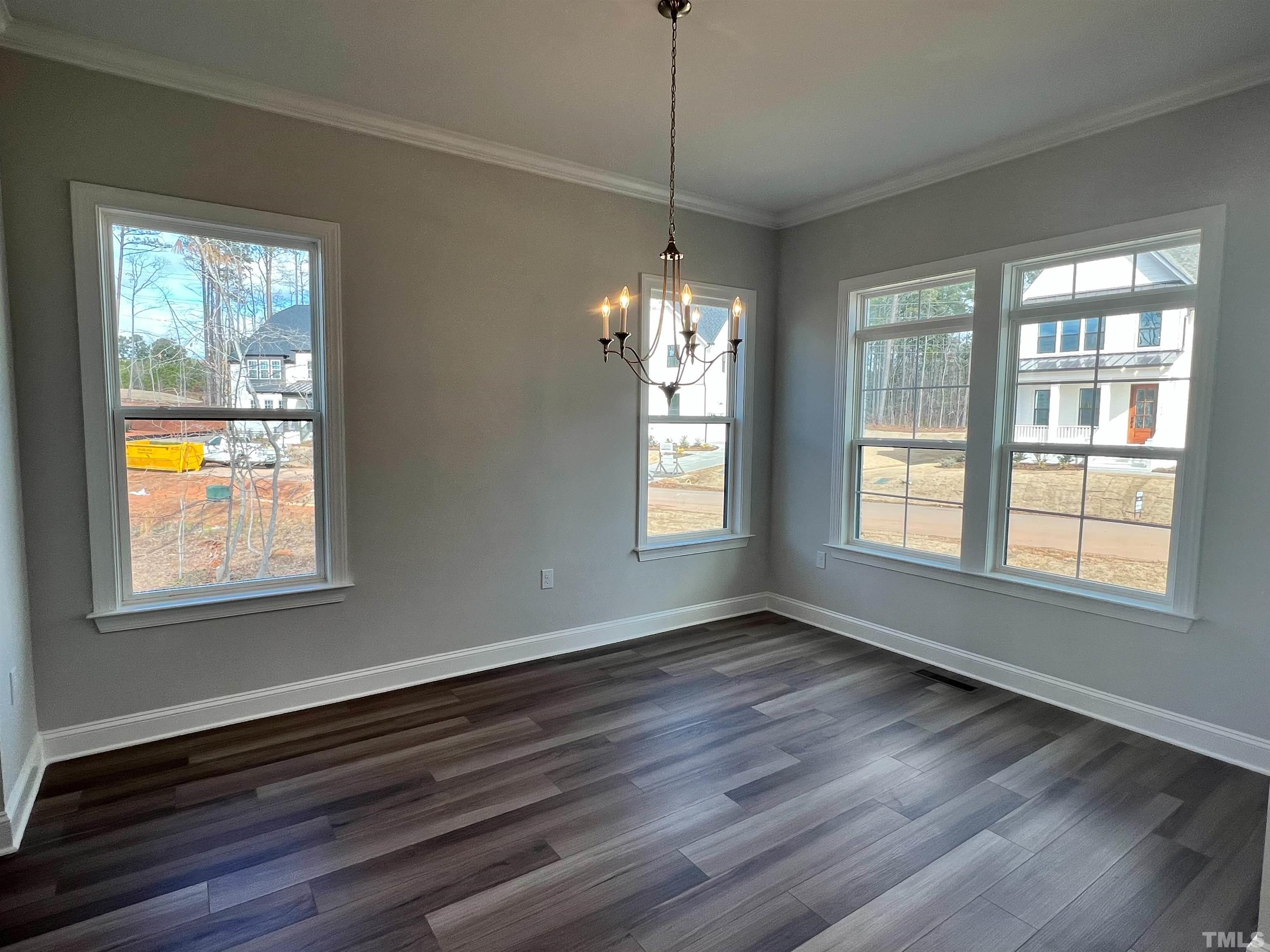 7613 Hasentree Way Wake Forest, NC 27587 - Photo 6 of 39 a view of an empty room with wooden floor and a window