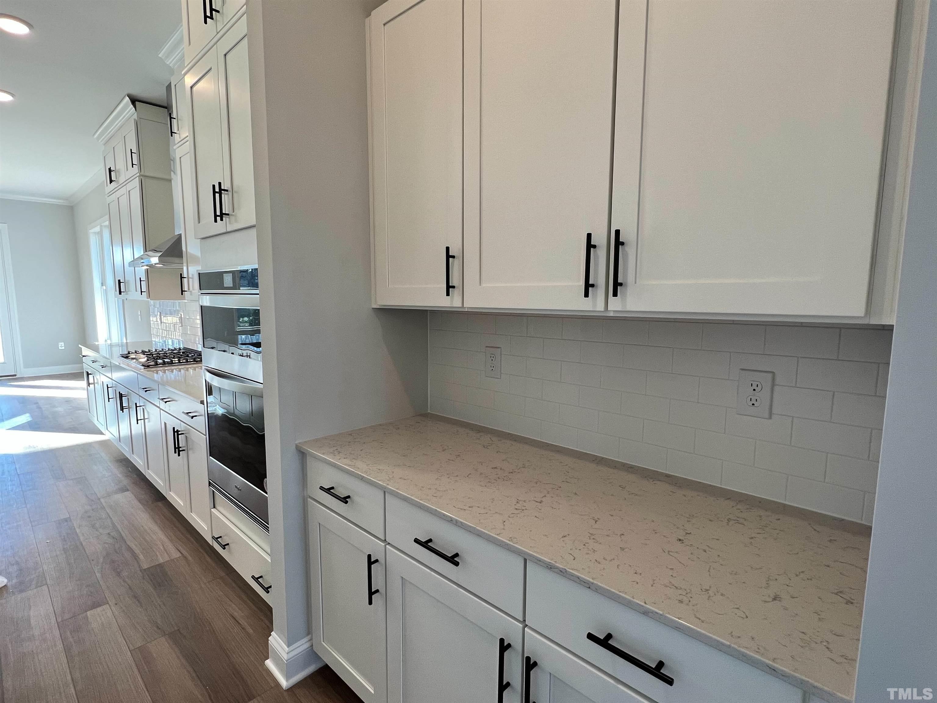 7613 Hasentree Way Wake Forest, NC 27587 - Photo 7 of 39 a kitchen with stainless steel appliances white cabinets and a sink