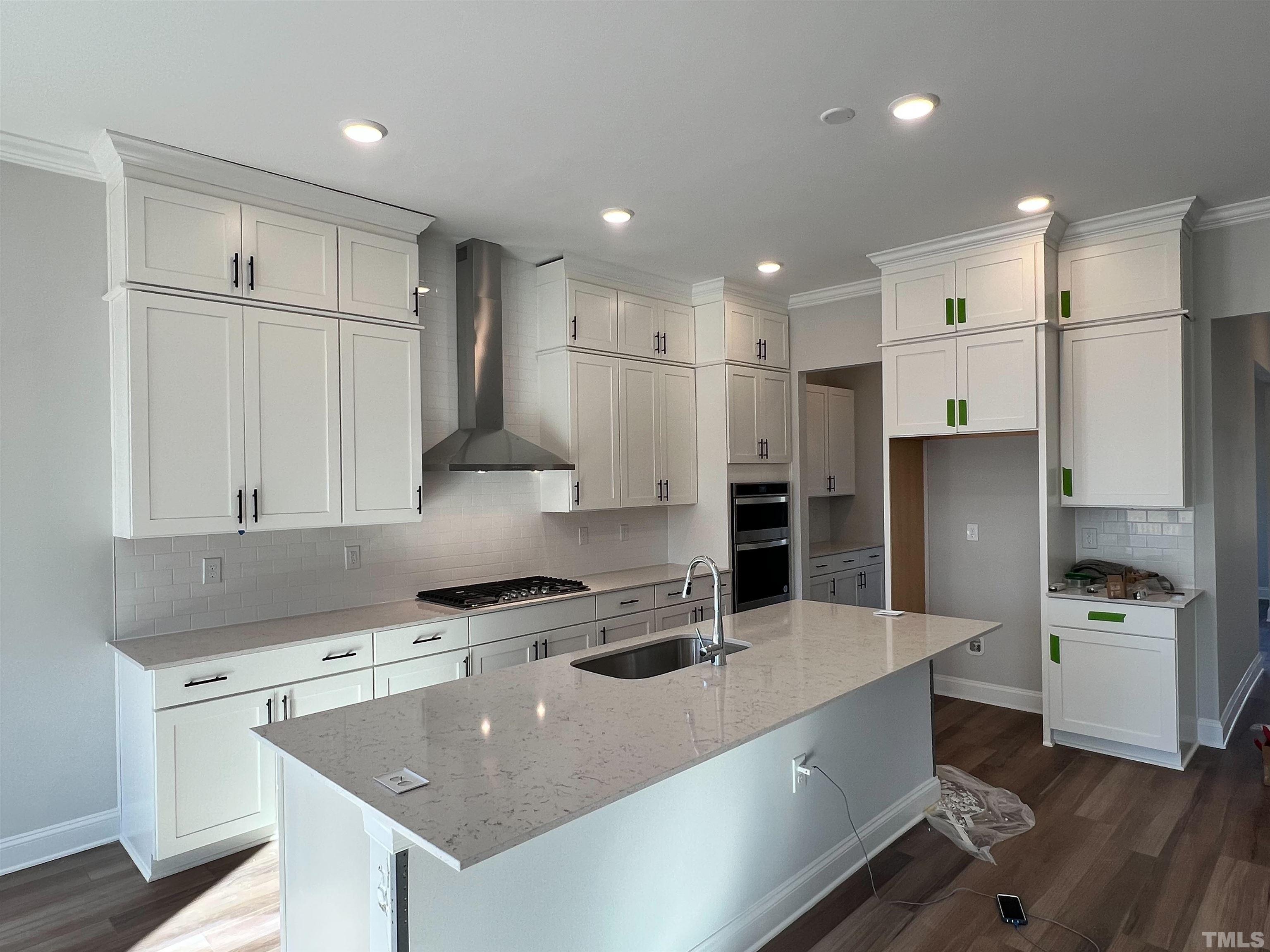 7613 Hasentree Way Wake Forest, NC 27587 - Photo 8 of 39 a kitchen with stainless steel appliances granite countertop a sink stove and refrigerator
