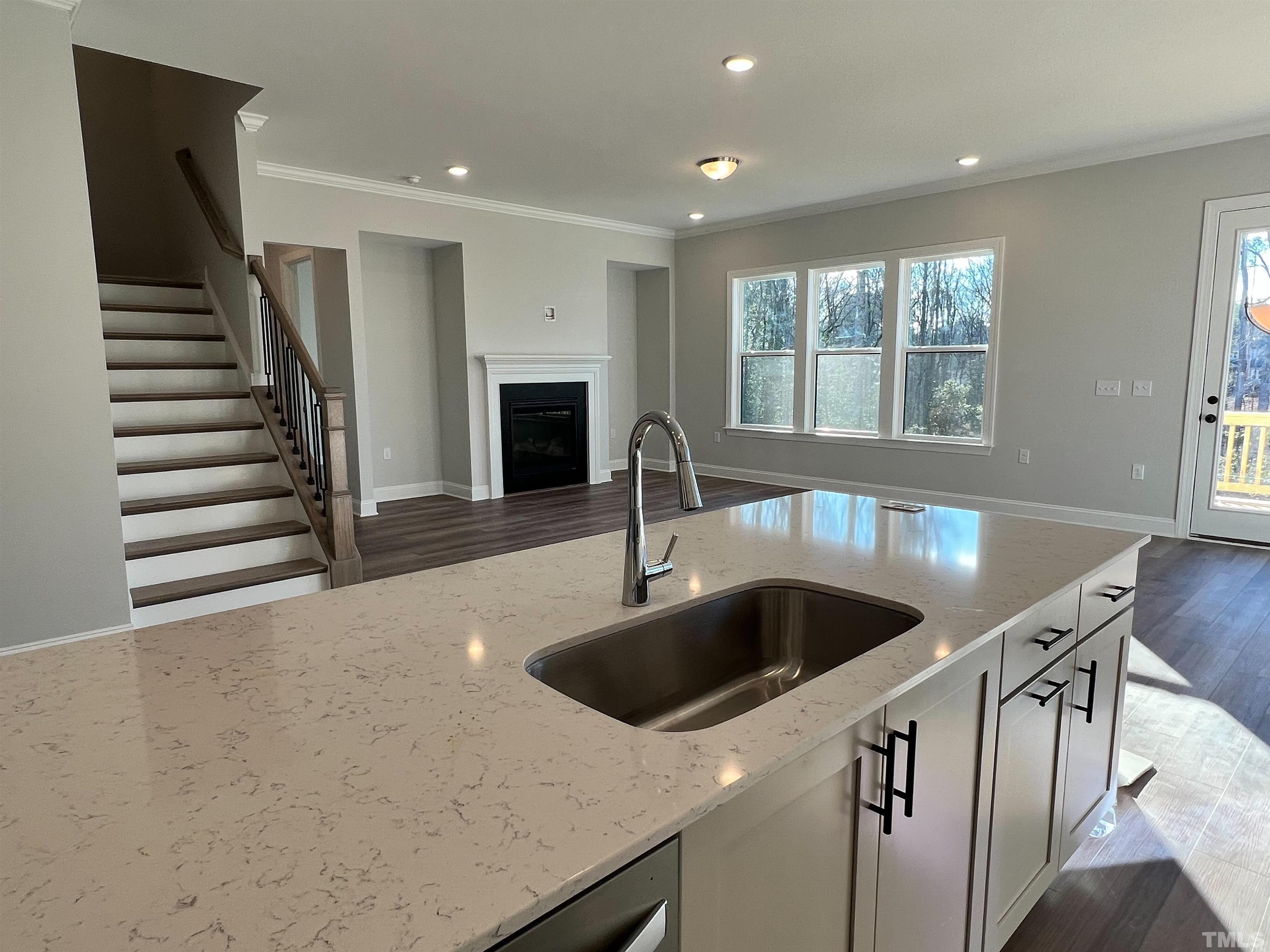 7613 Hasentree Way Wake Forest, NC 27587 - Photo 10 of 39 a kitchen with stainless steel appliances granite countertop a sink and a refrigerator