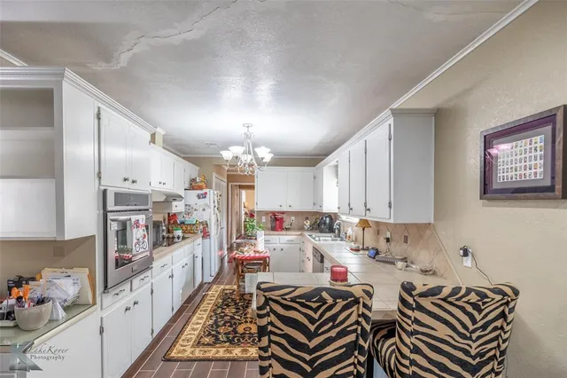 a kitchen with lots of appliances and cabinets