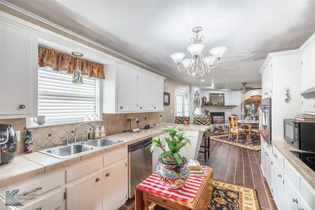 a kitchen with a sink stove and cabinets