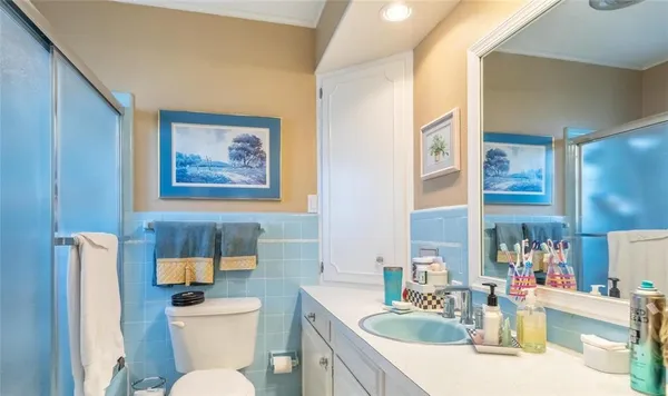 a bathroom with a toilet a sink and mirror