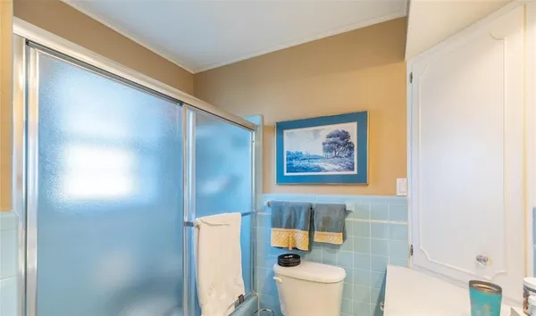 a bathroom with a toilet and a shower