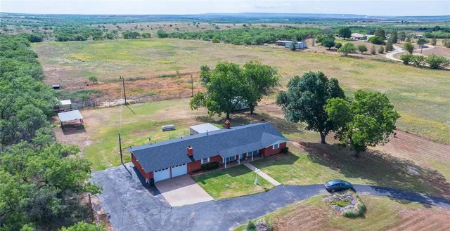 an aerial view of a house with a lake view
