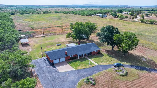 an aerial view of a house with a lake view