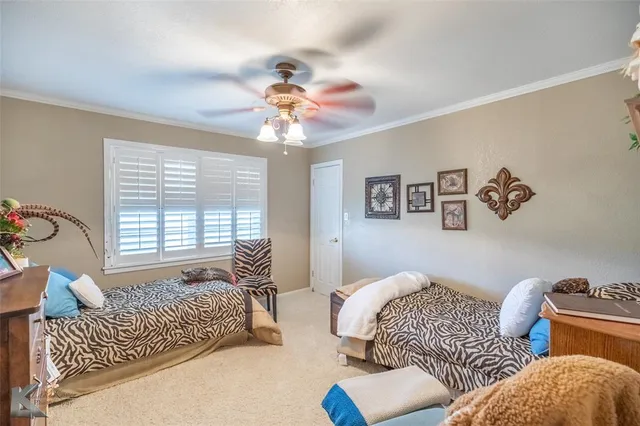 a bedroom with furniture and a large window